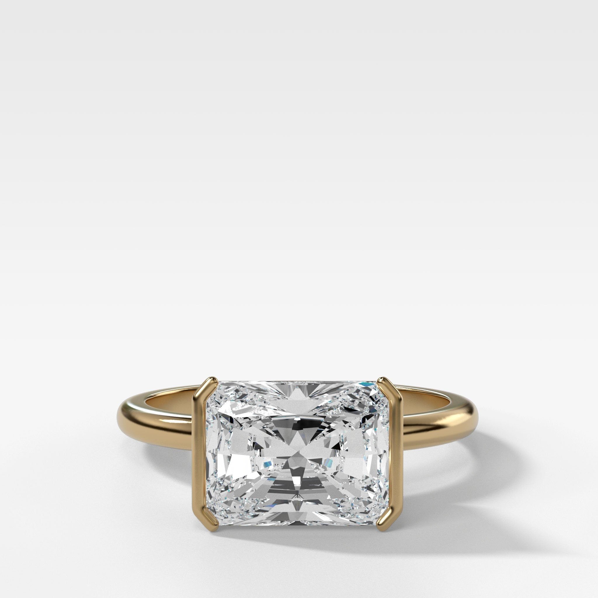 East West Half Bezel Solitaire Engagement Ring With Elongated Radiant Cut Diamond