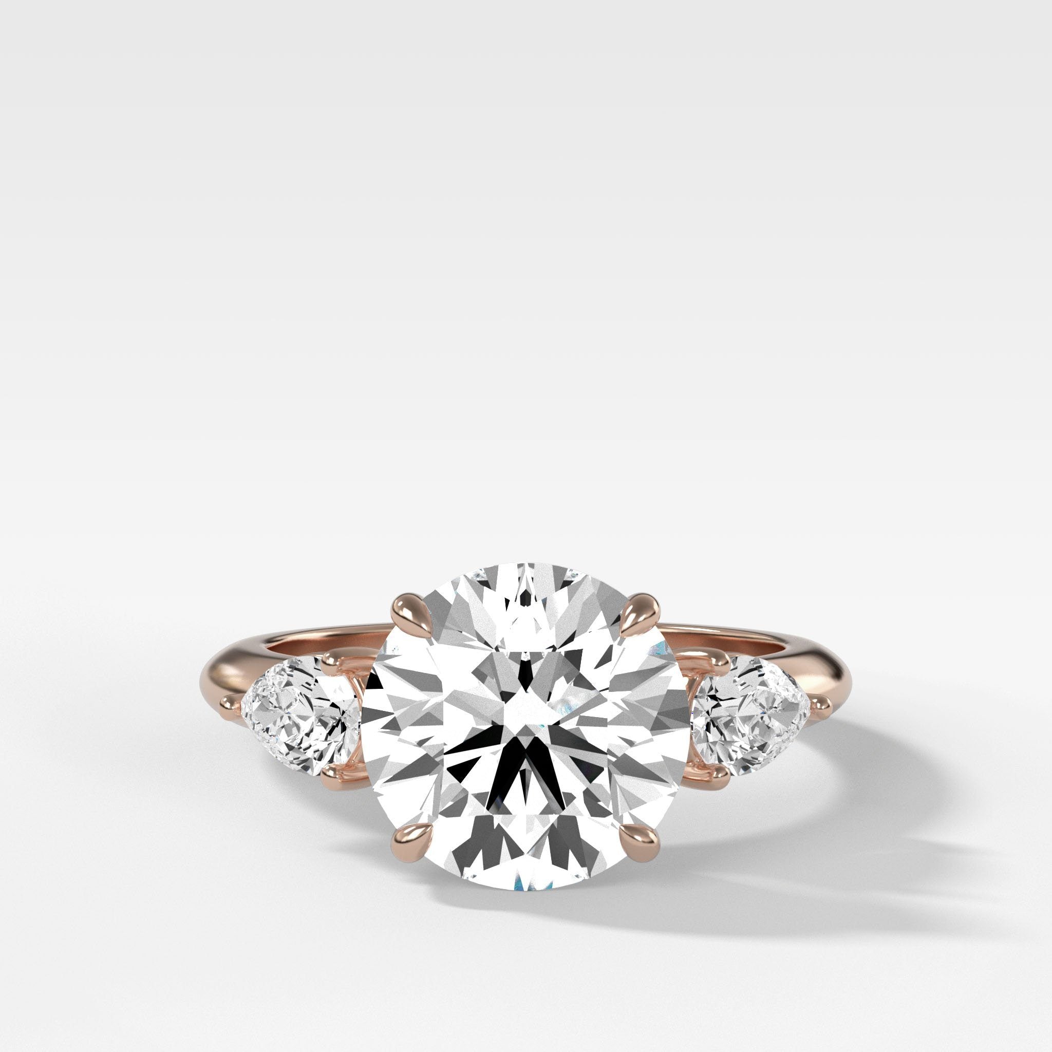 Three Stone Engagement Ring With Pear Side Stones With Round Cut Diamond