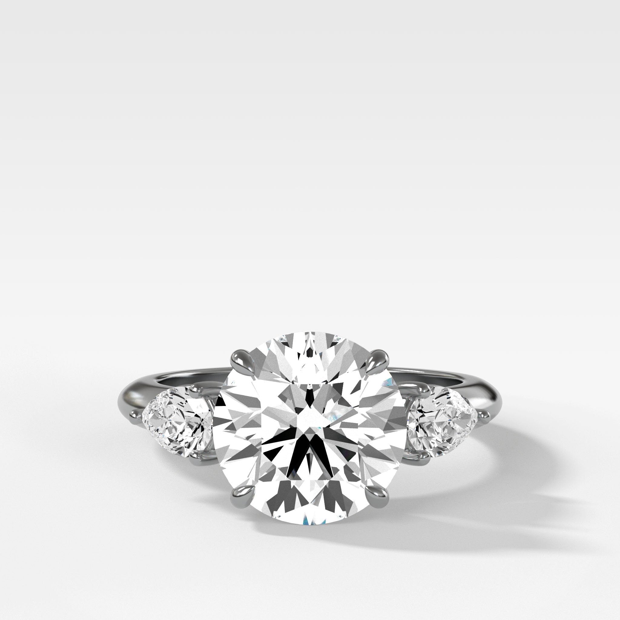 Three Stone Engagement Ring With Pear Side Stones With Round Cut Diamond