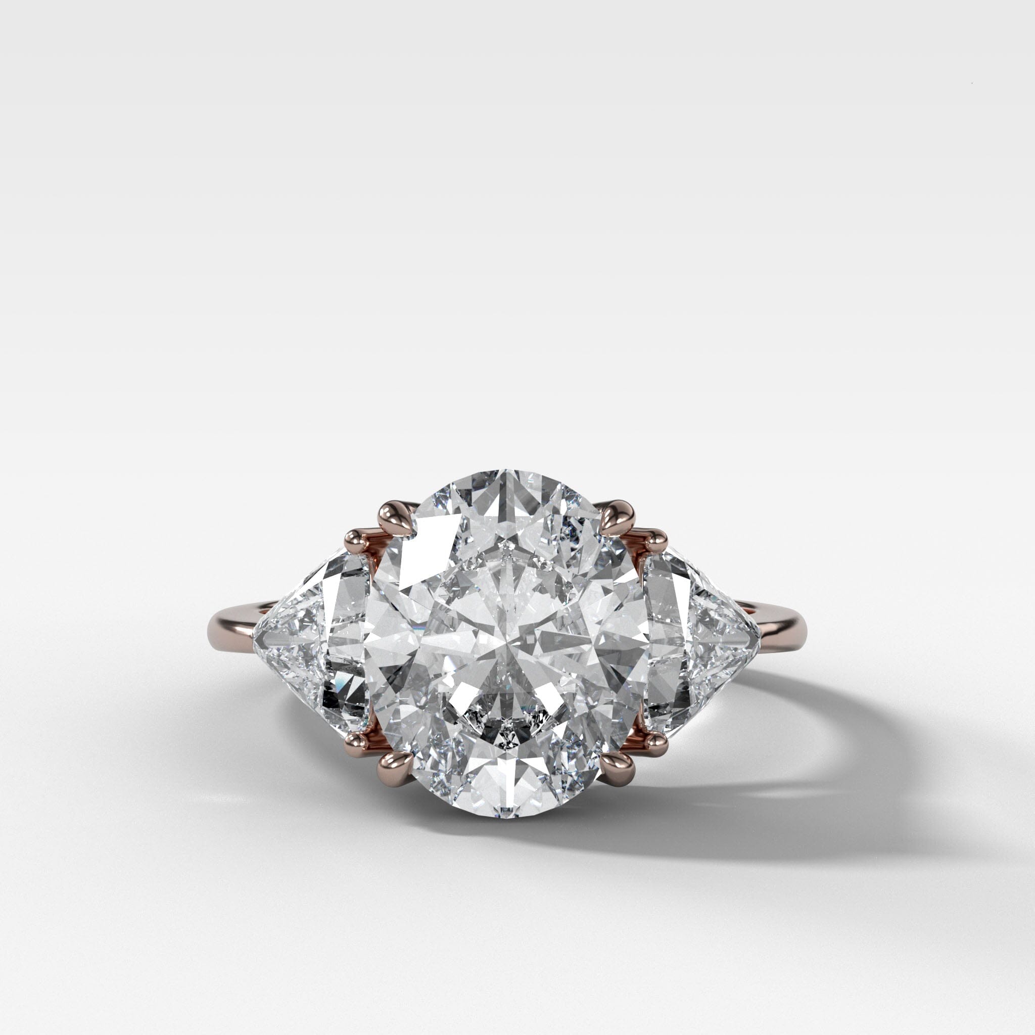 Three Stone Engagement Ring with Shield Side Stones and an Oval cut Diamond