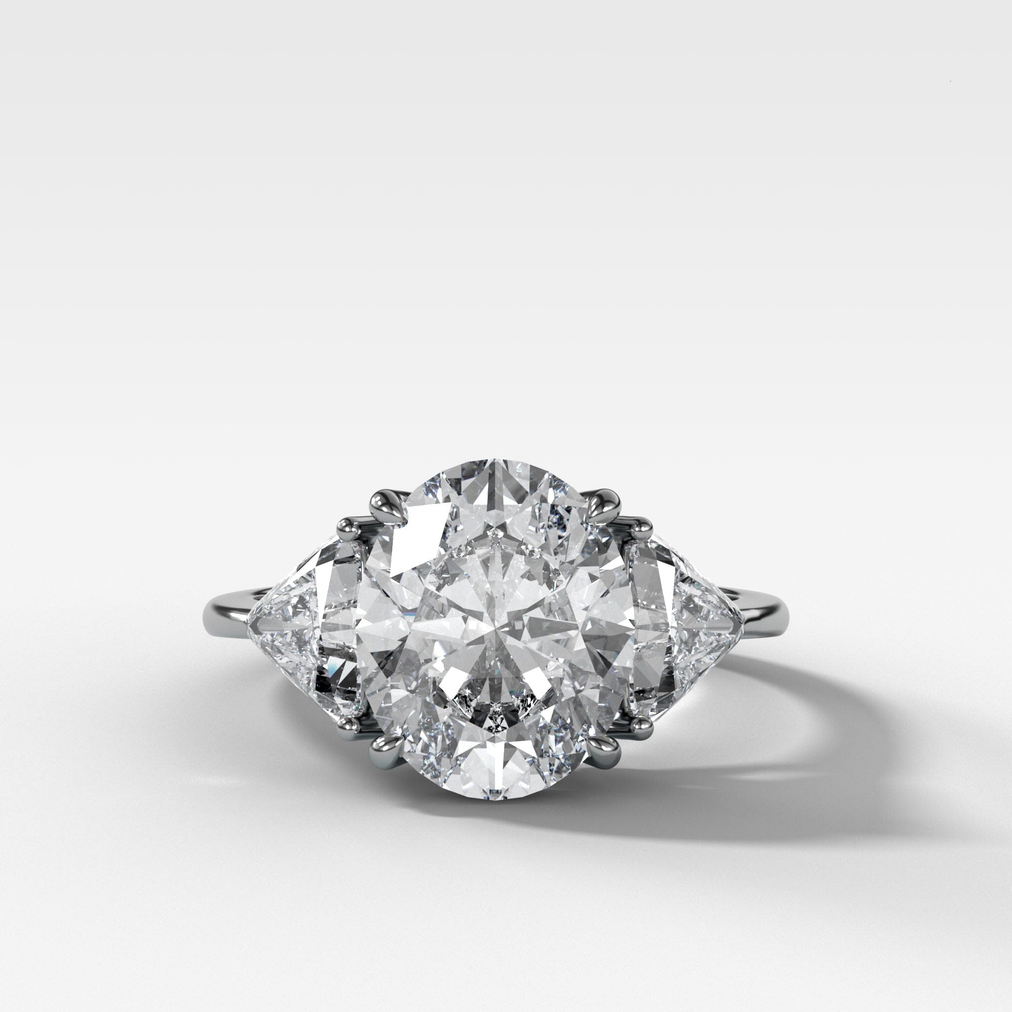 Three Stone Engagement Ring with Shield Side Stones and an Oval cut Diamond