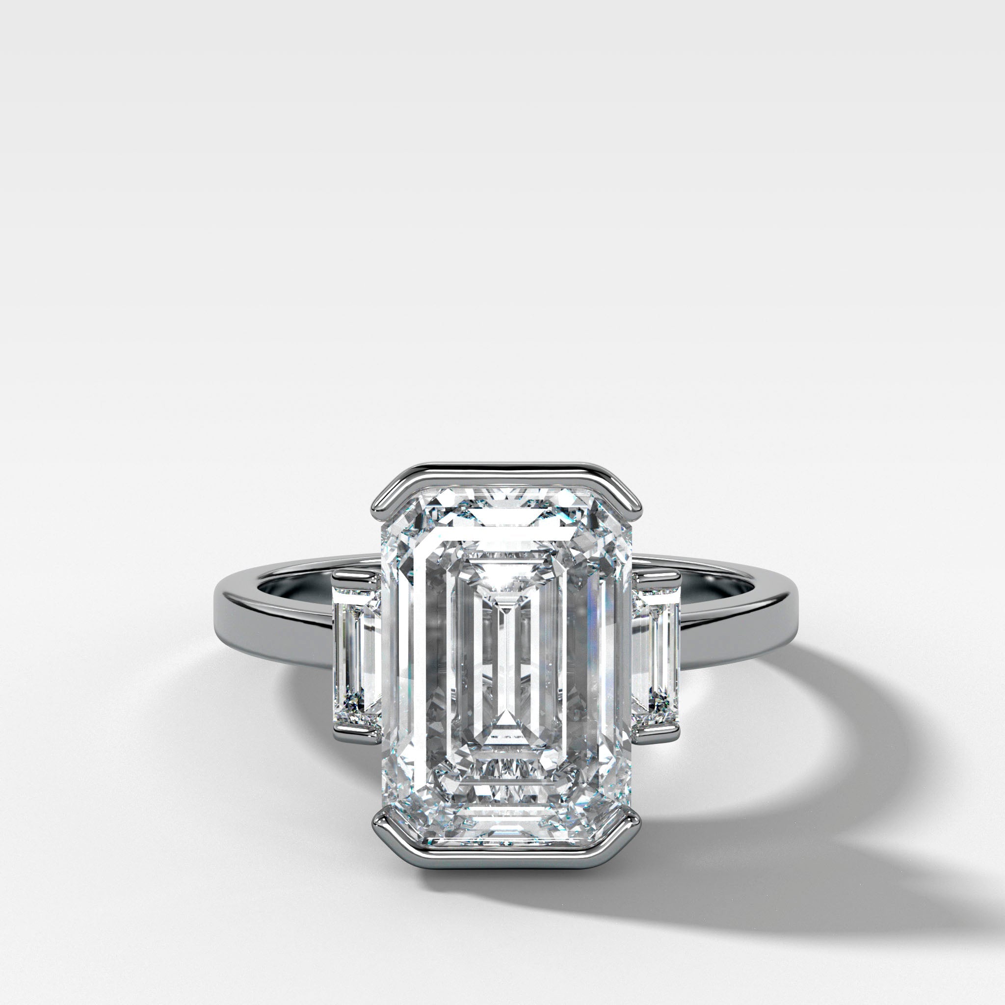 Three Stone Half Bezel Engagement Ring with Baguette Side Stones and Emerald Cut Diamond
