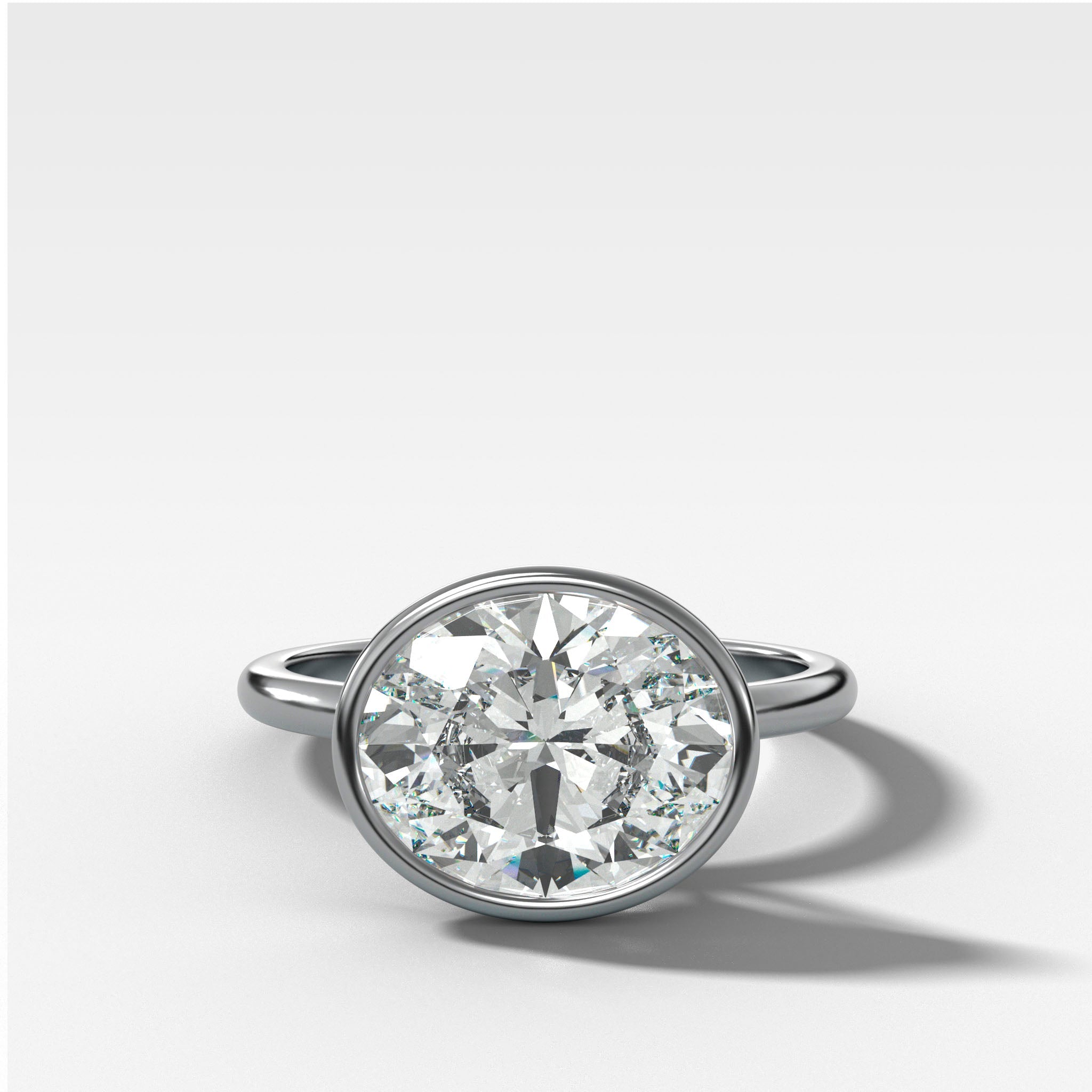 Penumbra Bezel Set Engagement Ring With East West Oval Cut