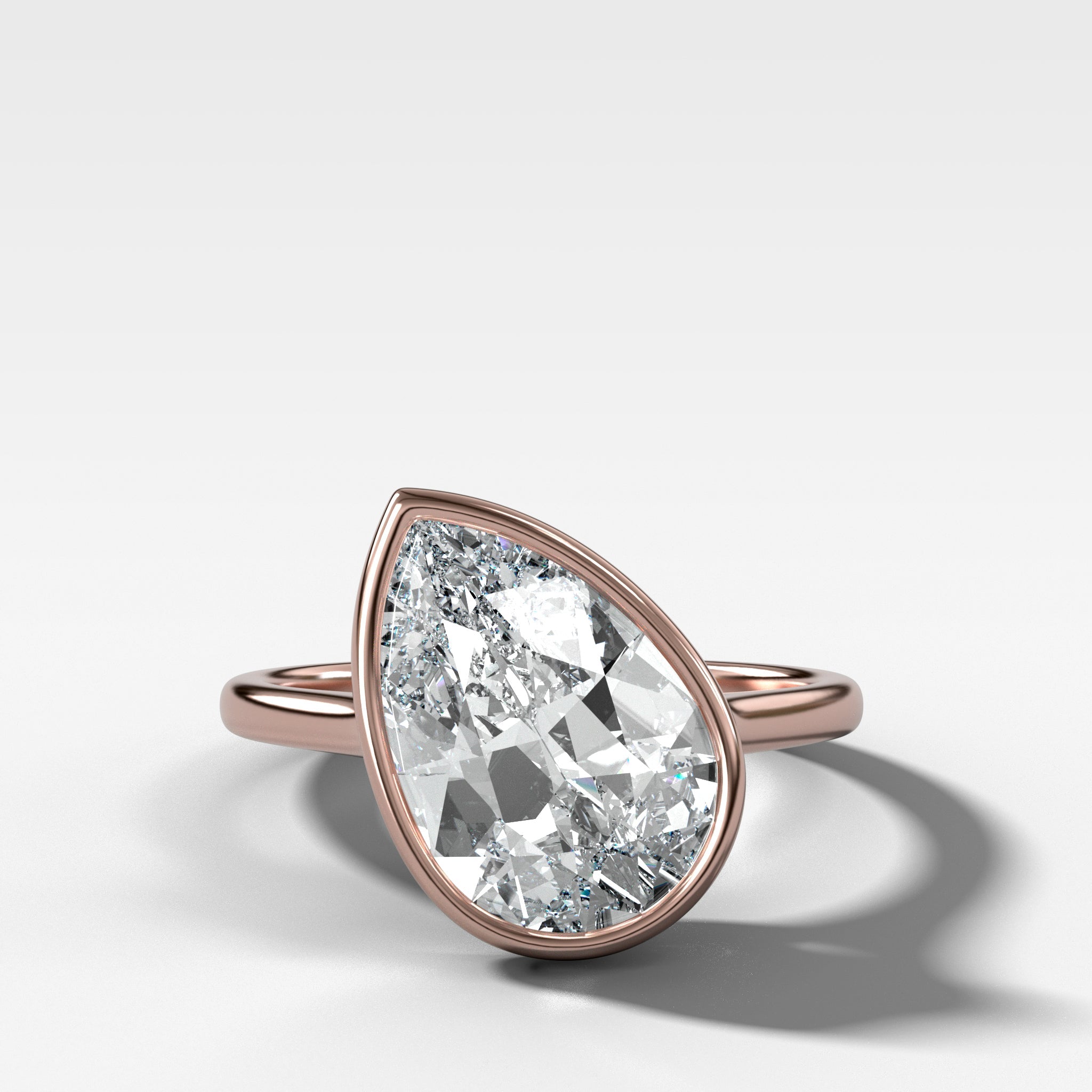 Penumbra Bezel Set Engagement Ring With Tilted Pear Cut