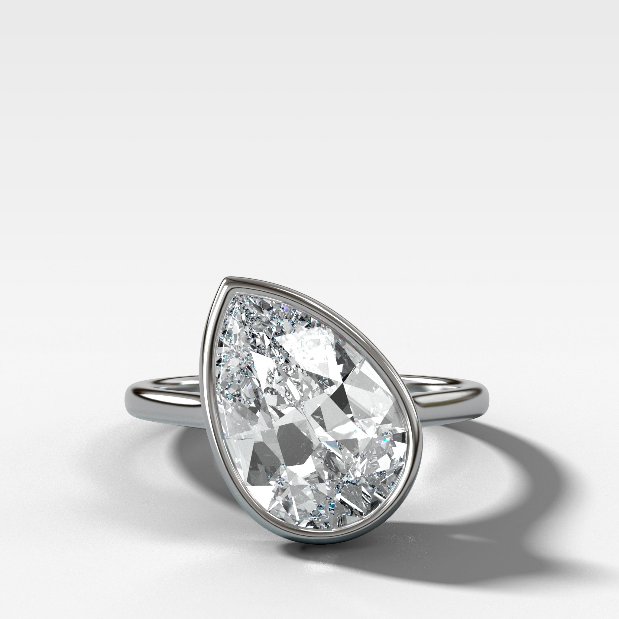 Penumbra Bezel Set Engagement Ring With Tilted Pear Cut