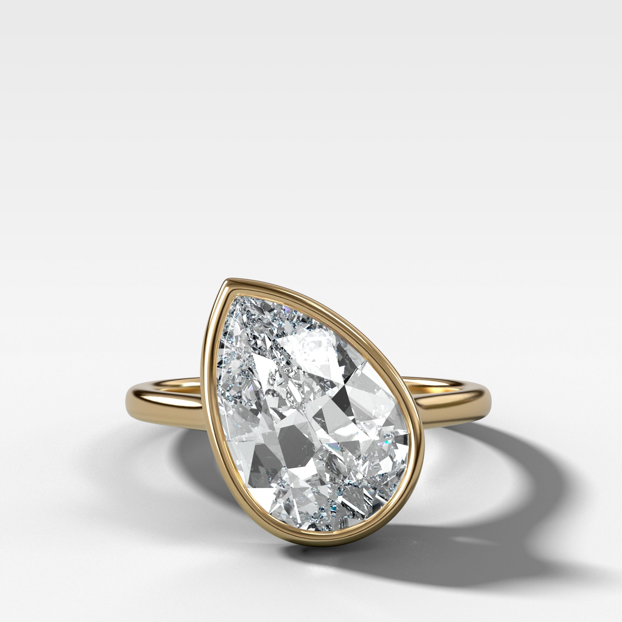 Penumbra Bezel Set Engagement Ring With Tilted Pear Cut