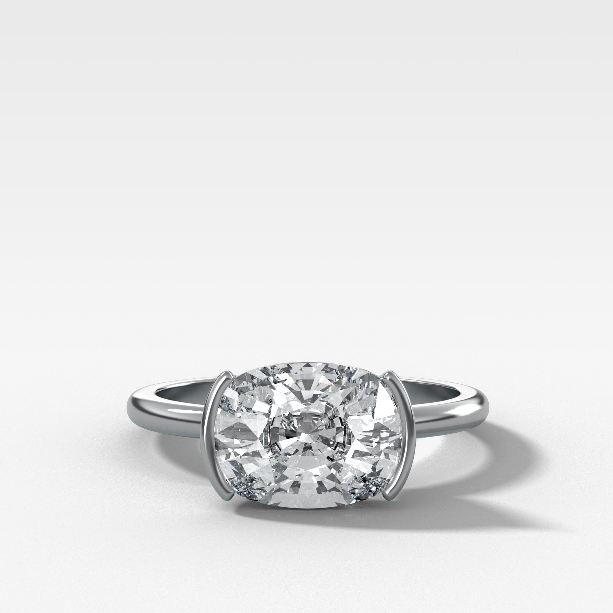 East West Half Bezel Solitaire Engagement Ring With Elongated Cushion Cut Diamond