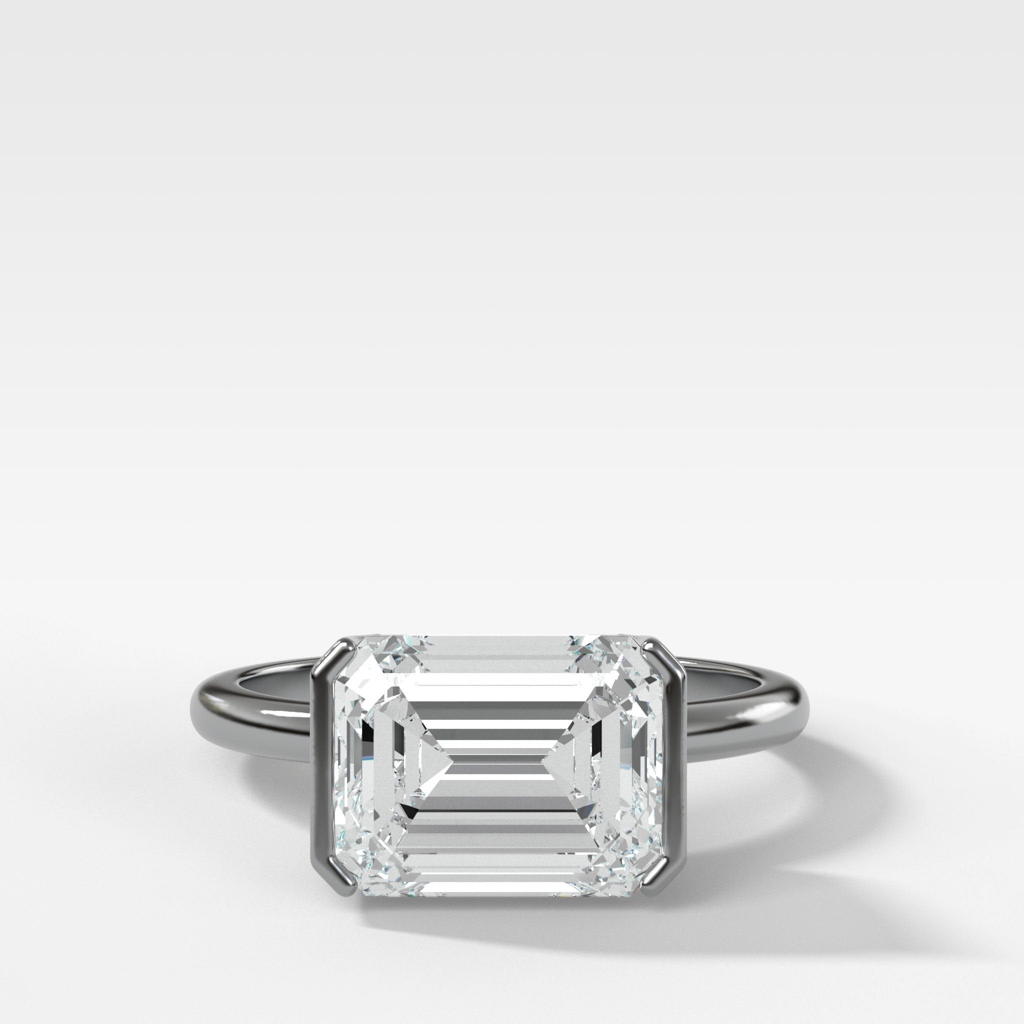 East West Half Bezel Solitaire Engagement Ring With Emerald Cut Diamond