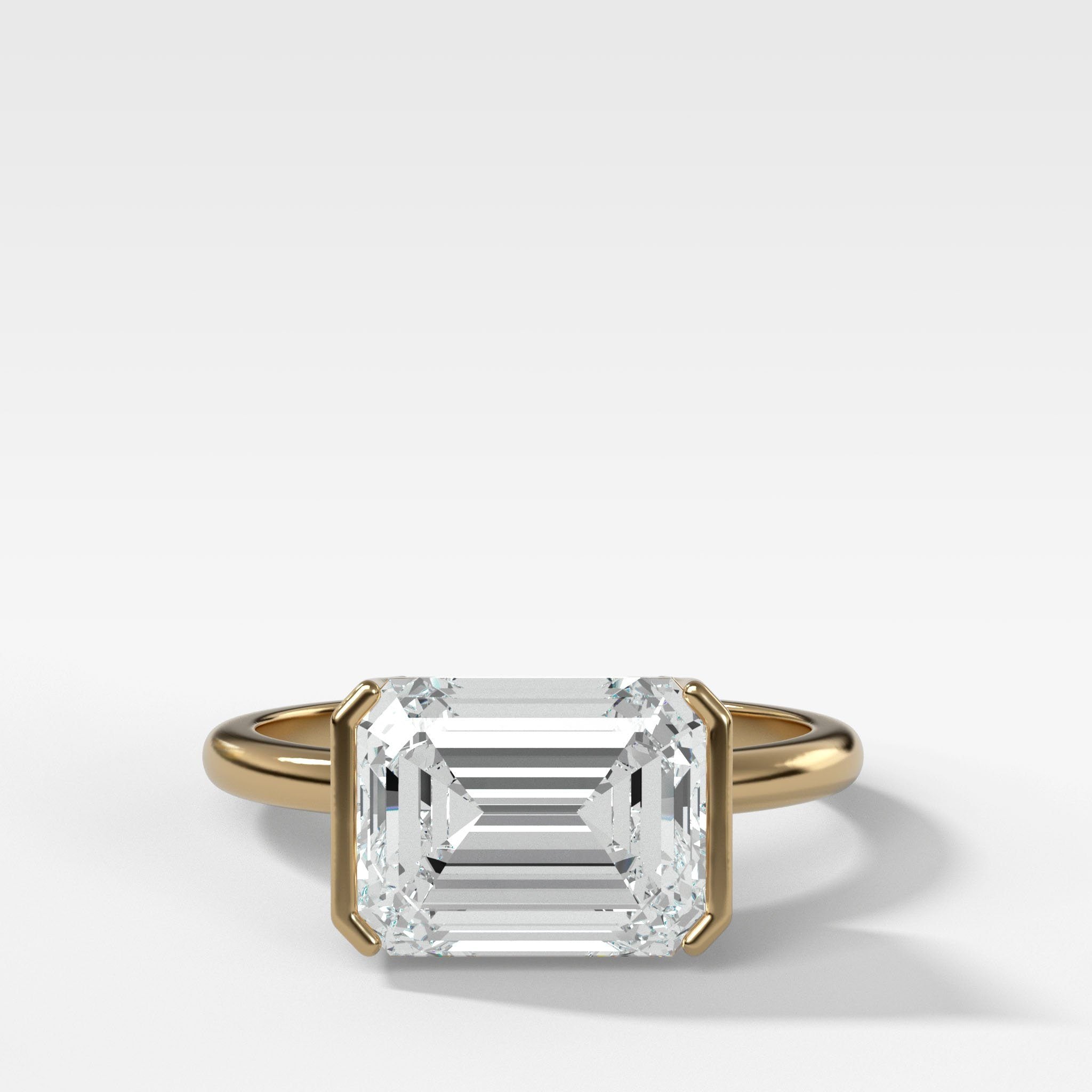 East West Half Bezel Solitaire Engagement Ring With Emerald Cut Diamond