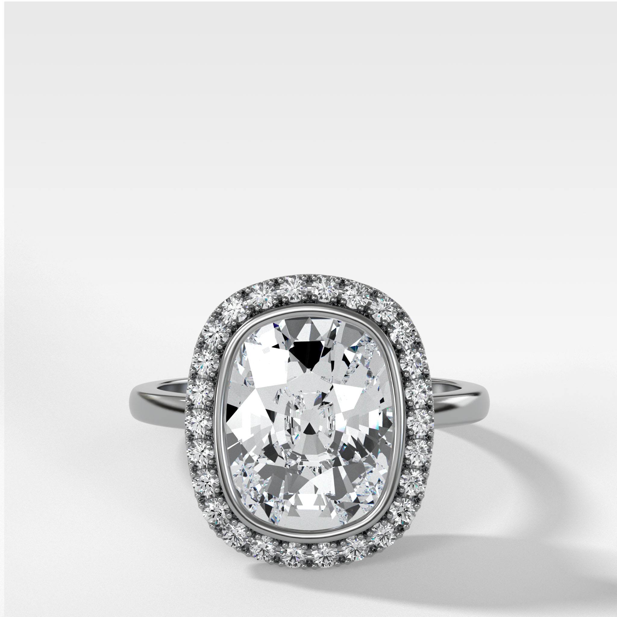 Bezel Set Halo Engagement Ring With Elongated Cushion Cut Diamond
