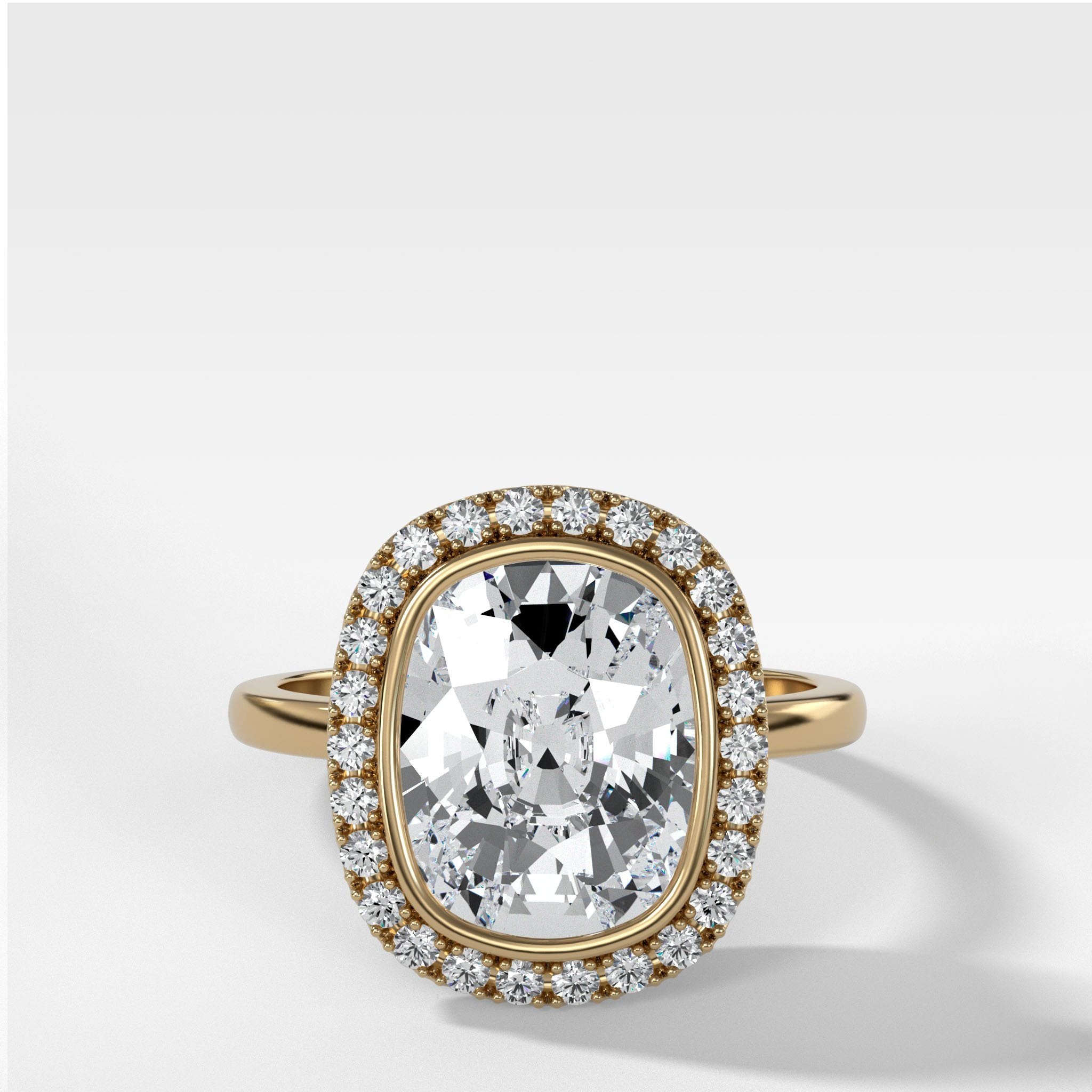 Bezel Set Halo Engagement Ring With Elongated Cushion Cut Diamond