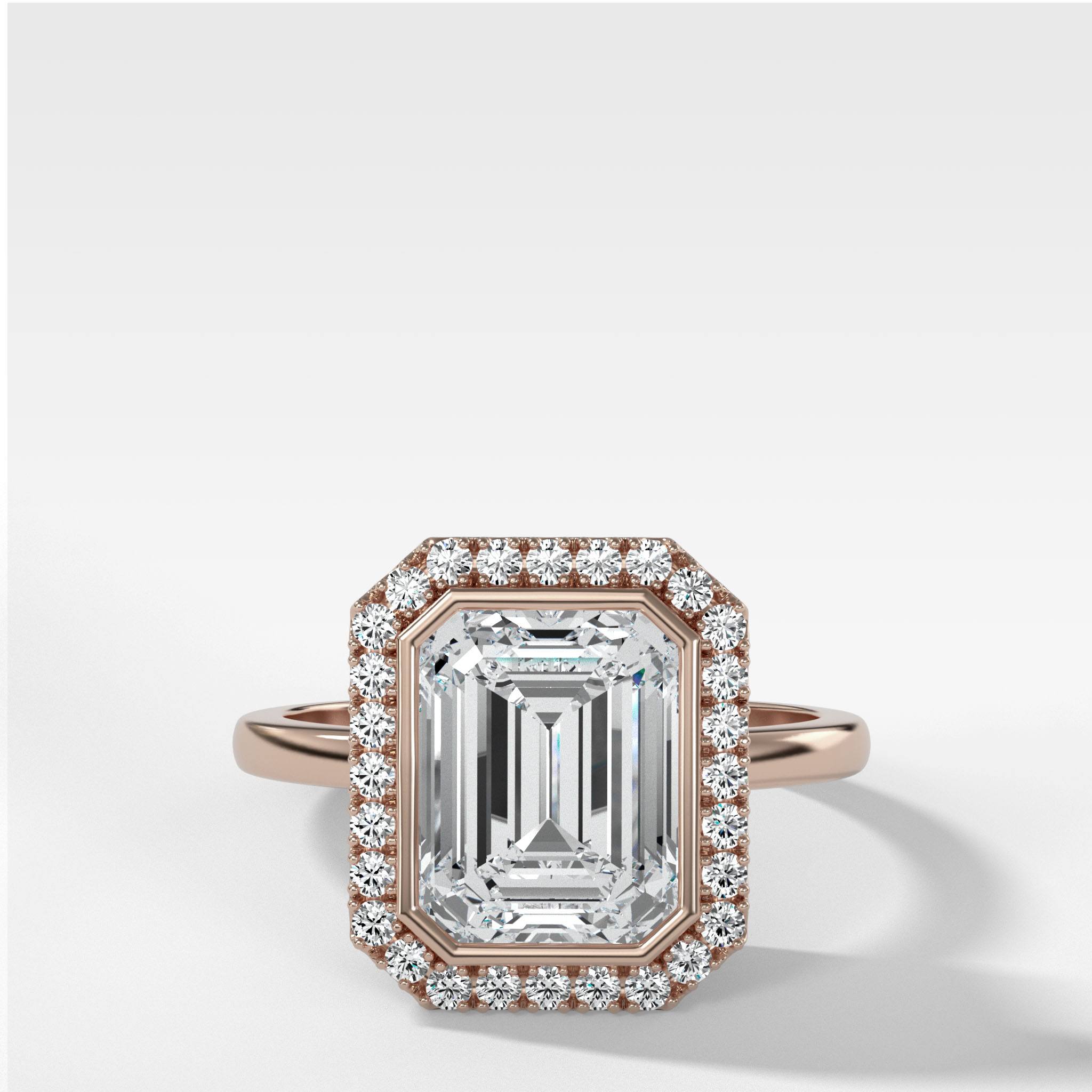 Bezel Set Halo Engagement Ring With Emerald Cut Diamond