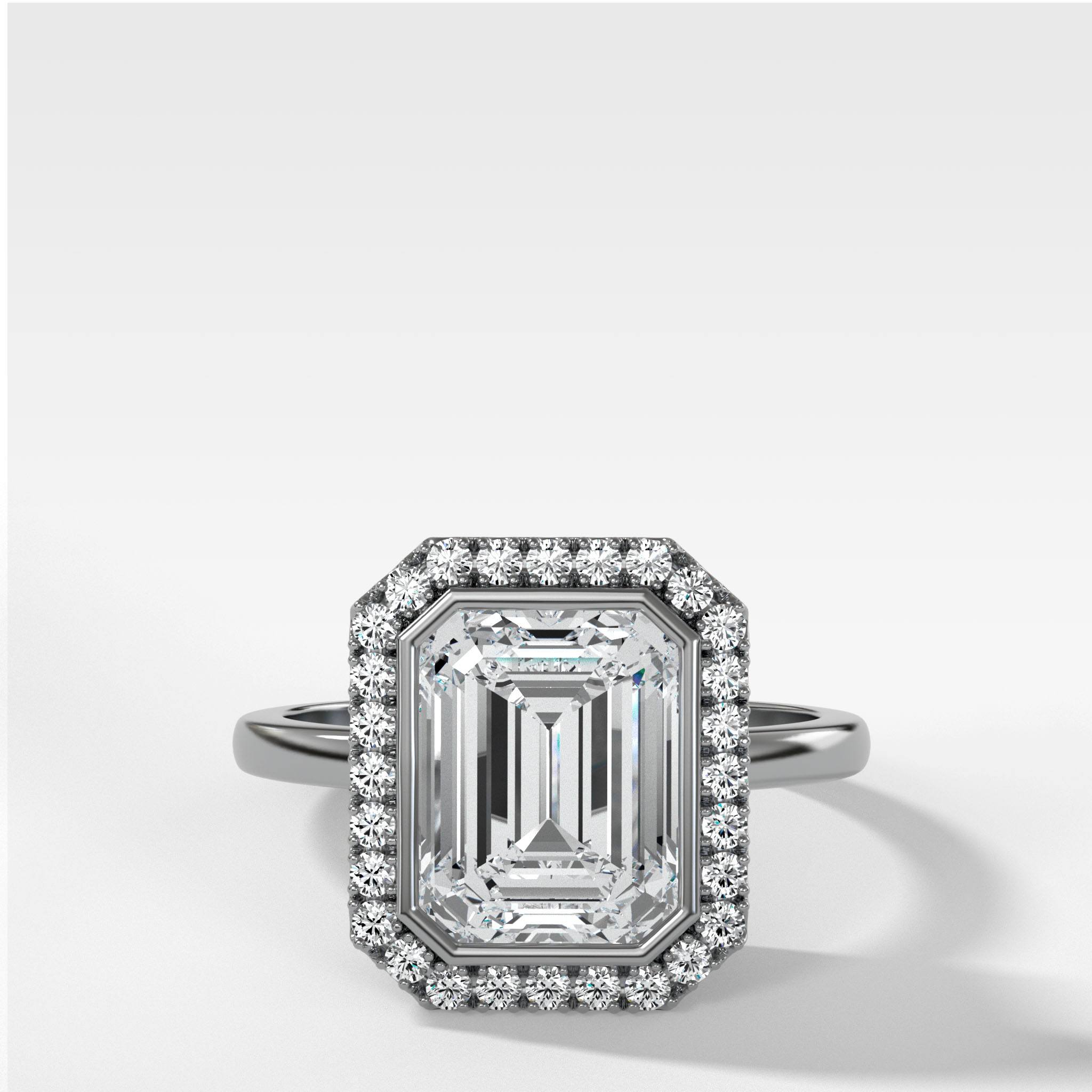 Bezel Set Halo Engagement Ring With Emerald Cut Diamond