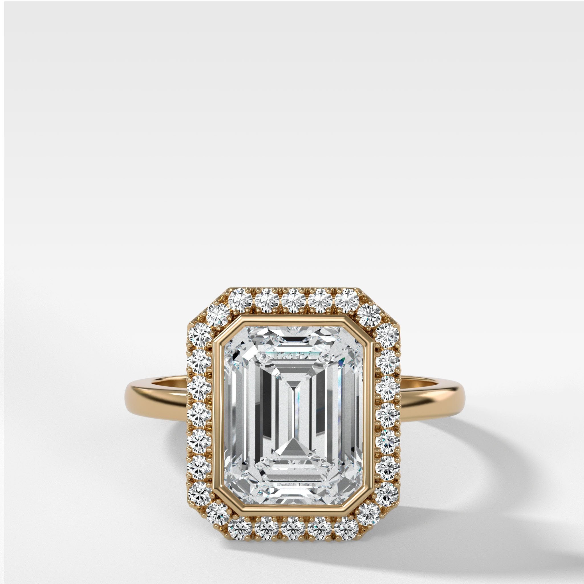 Bezel Set Halo Engagement Ring With Emerald Cut Diamond