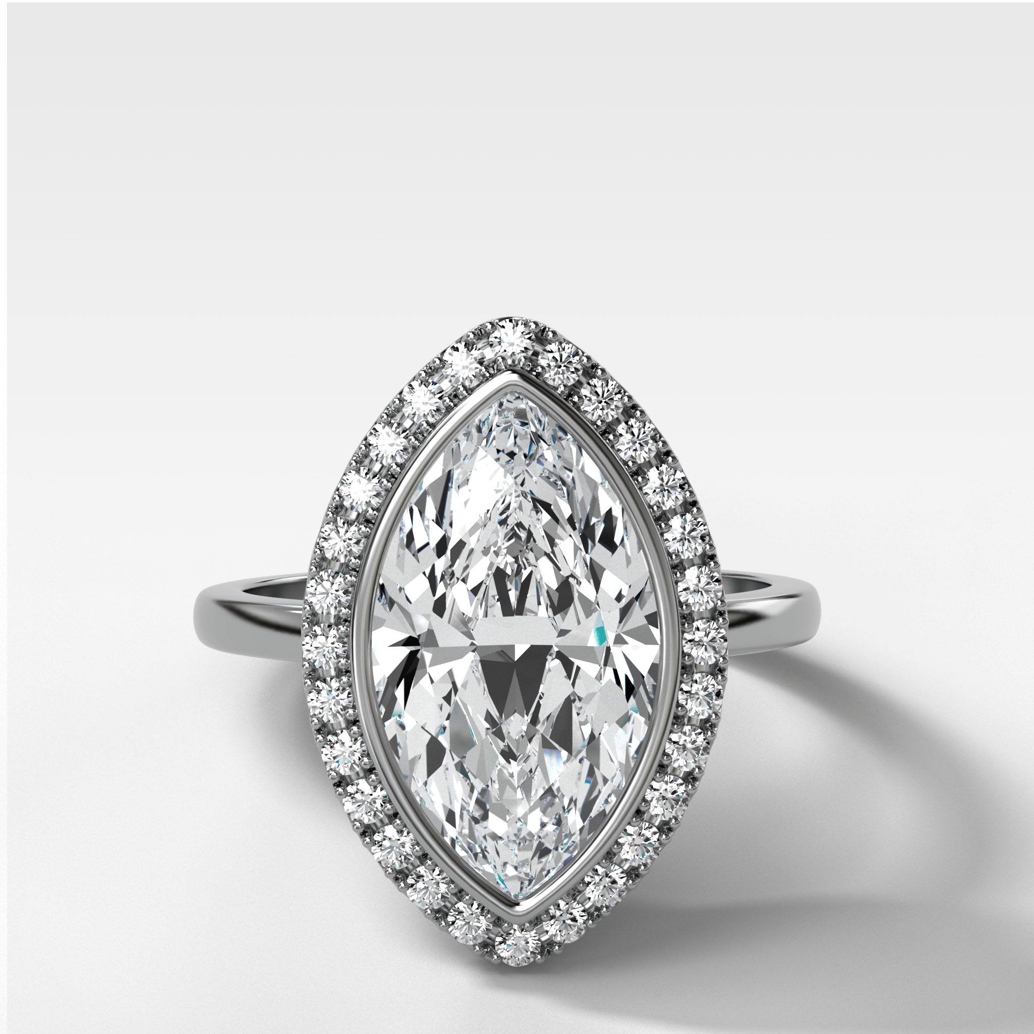 Bezel Set Halo Engagement Ring With Marquise Cut Diamond
