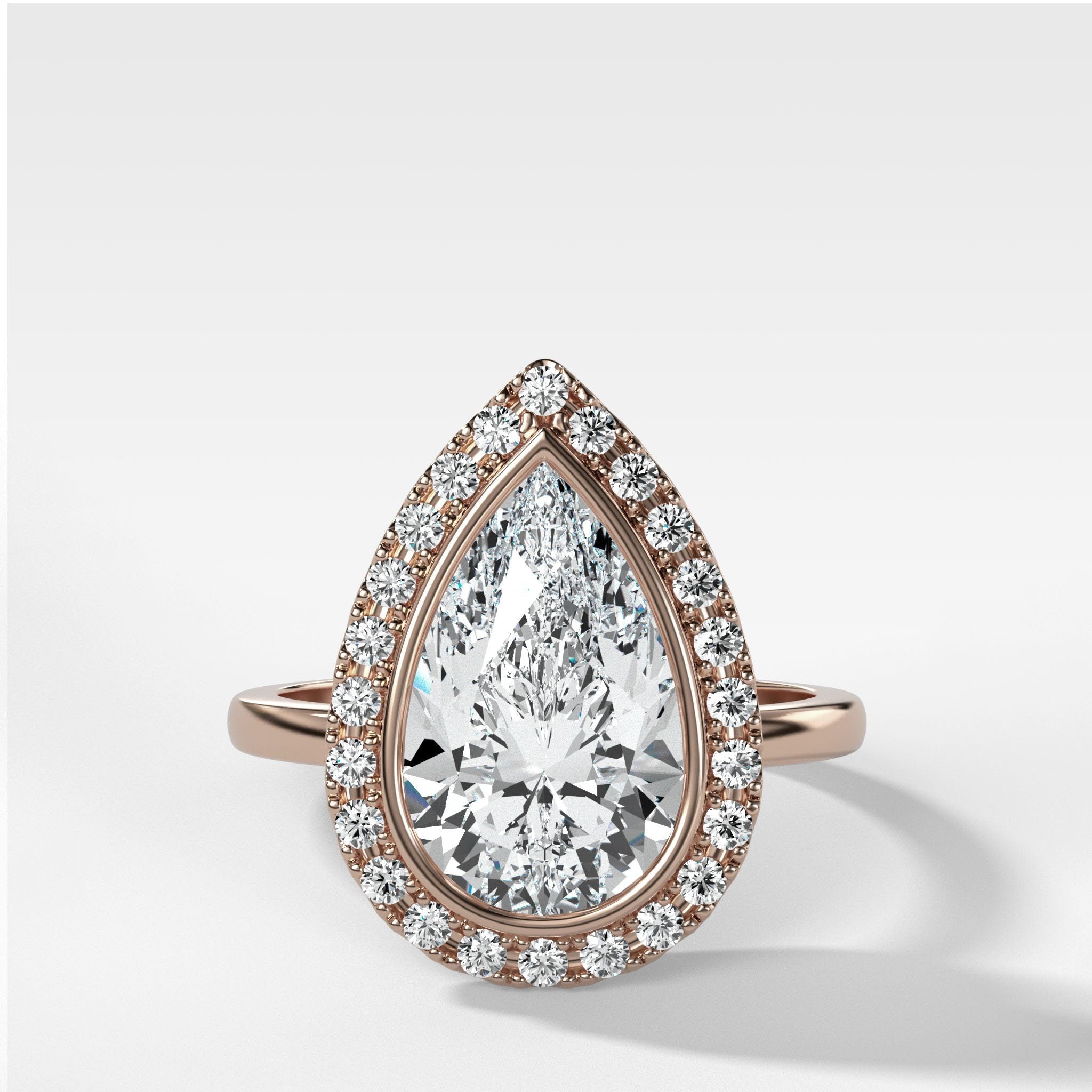 Bezel Set Halo Engagement Ring With Pear Cut Diamond