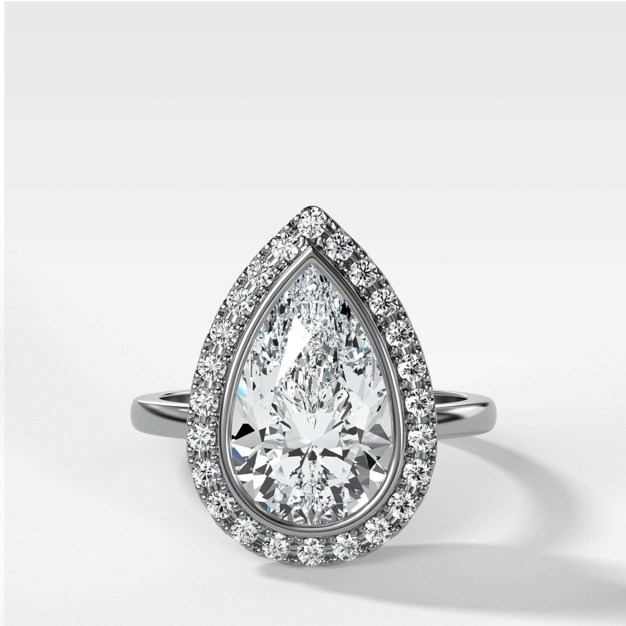 Bezel Set Halo Engagement Ring With Pear Cut Diamond