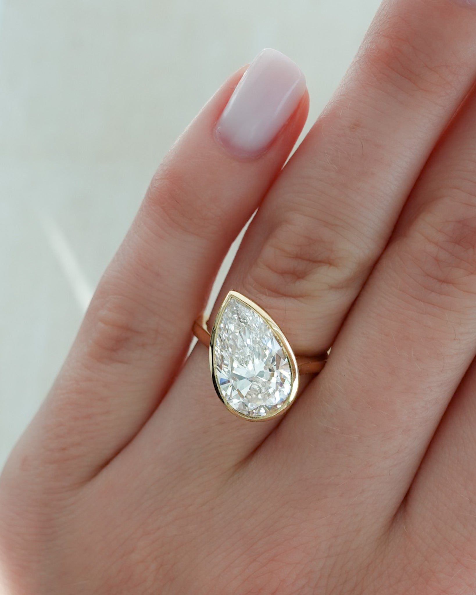 Penumbra Bezel Set Engagement Ring With Tilted Pear Cut