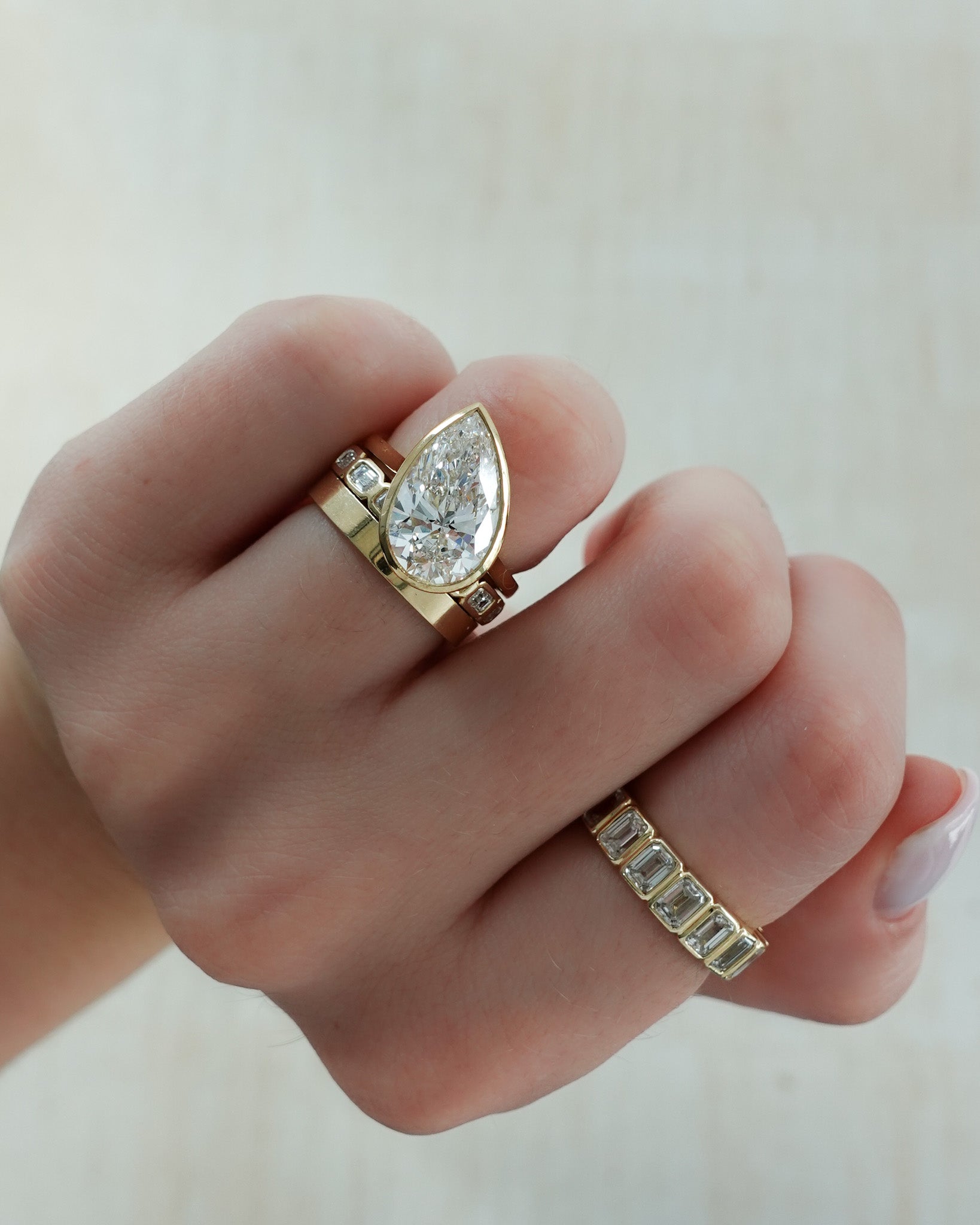 Penumbra Bezel Set Engagement Ring With Tilted Pear Cut