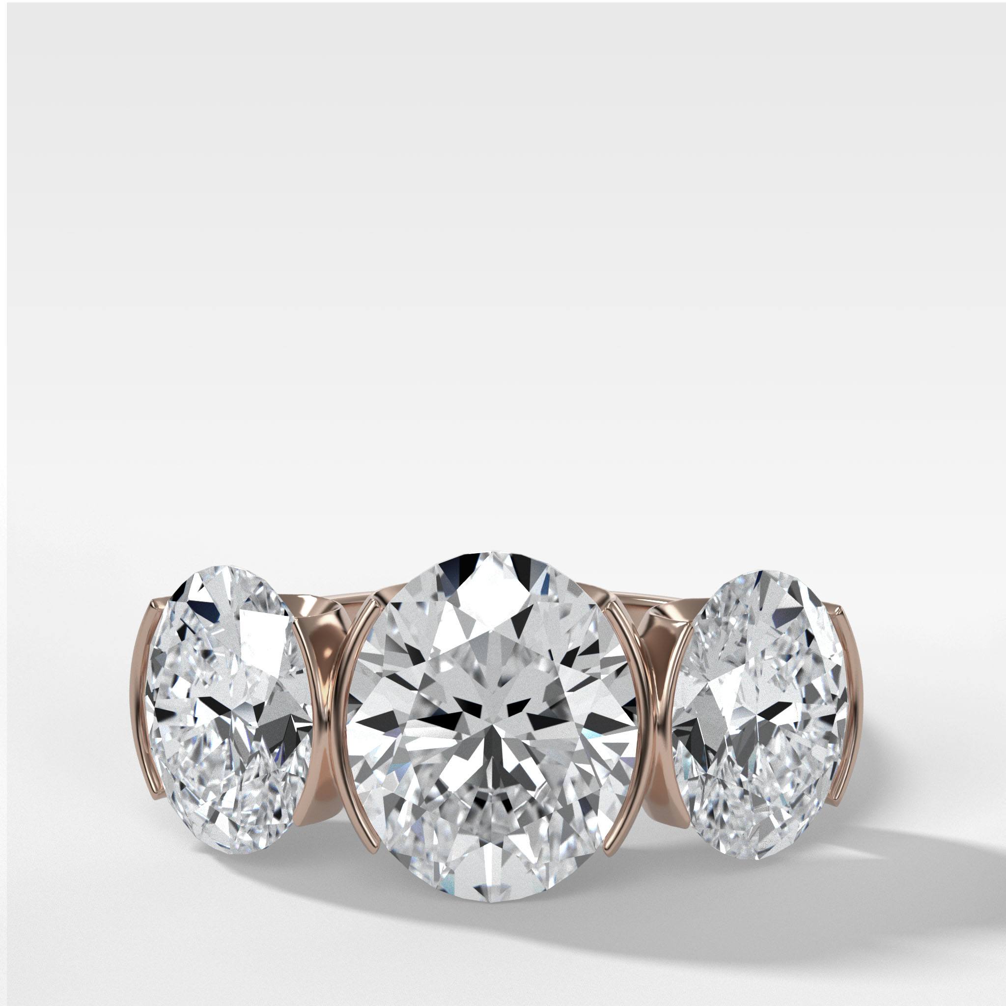 Half Bezel Triad Engagement Ring With Oval Cut Diamonds