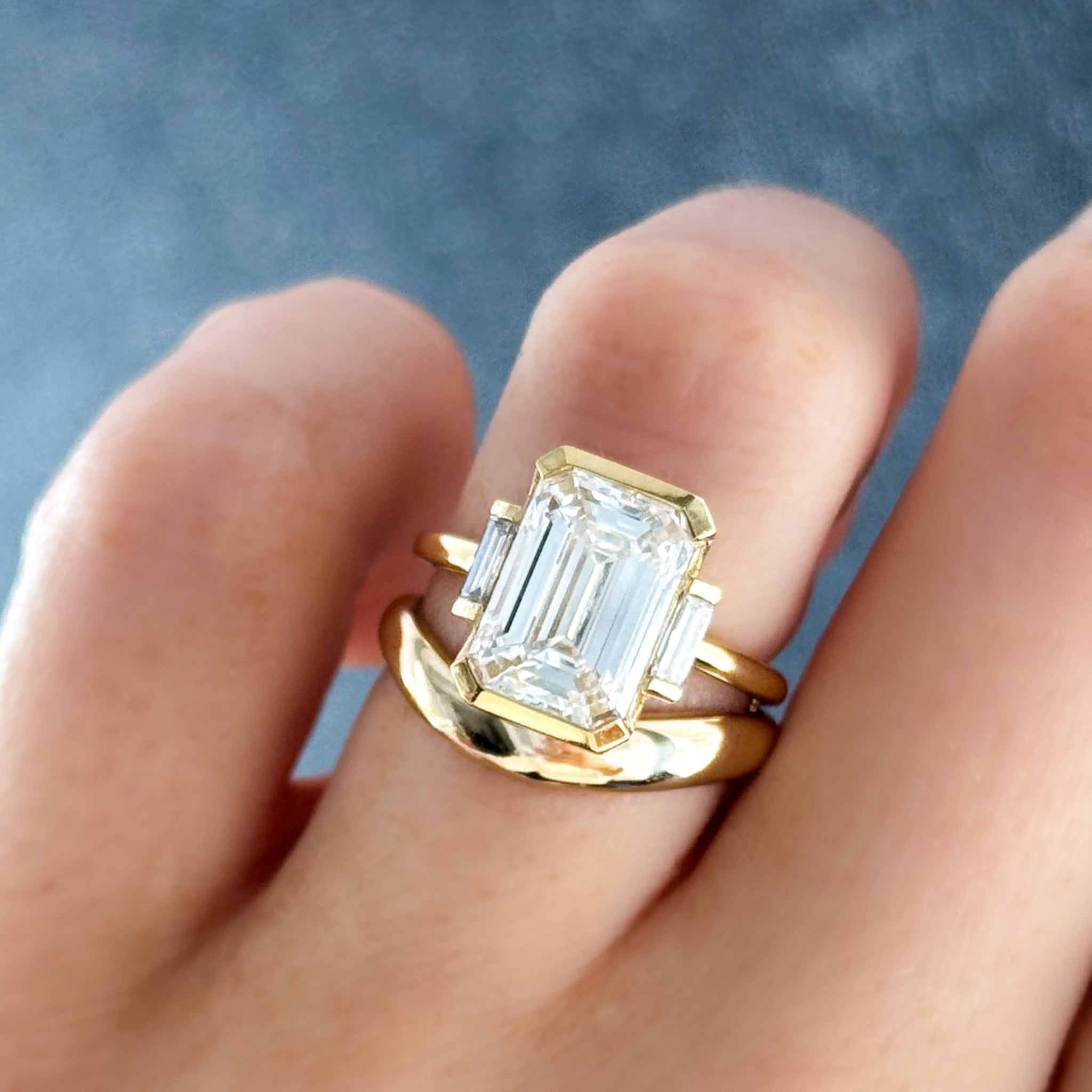 Three Stone Half Bezel Engagement Ring with Baguette Side Stones and Emerald Cut Diamond