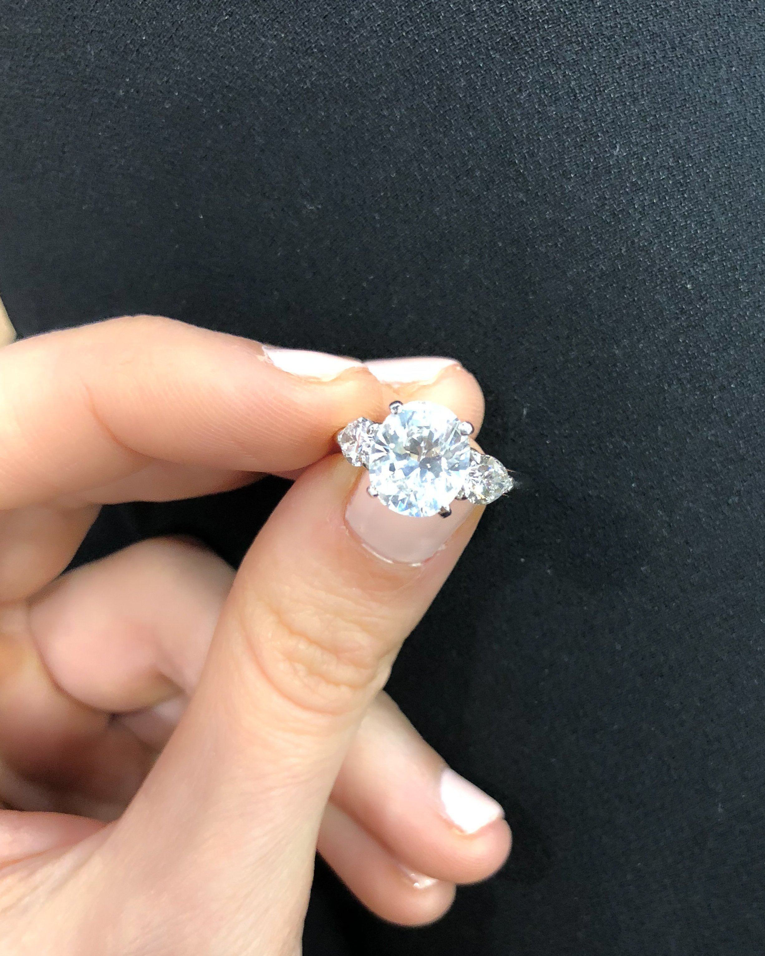 Three Stone Engagement Ring With Pear Side Stones and Oval Cut Diamond