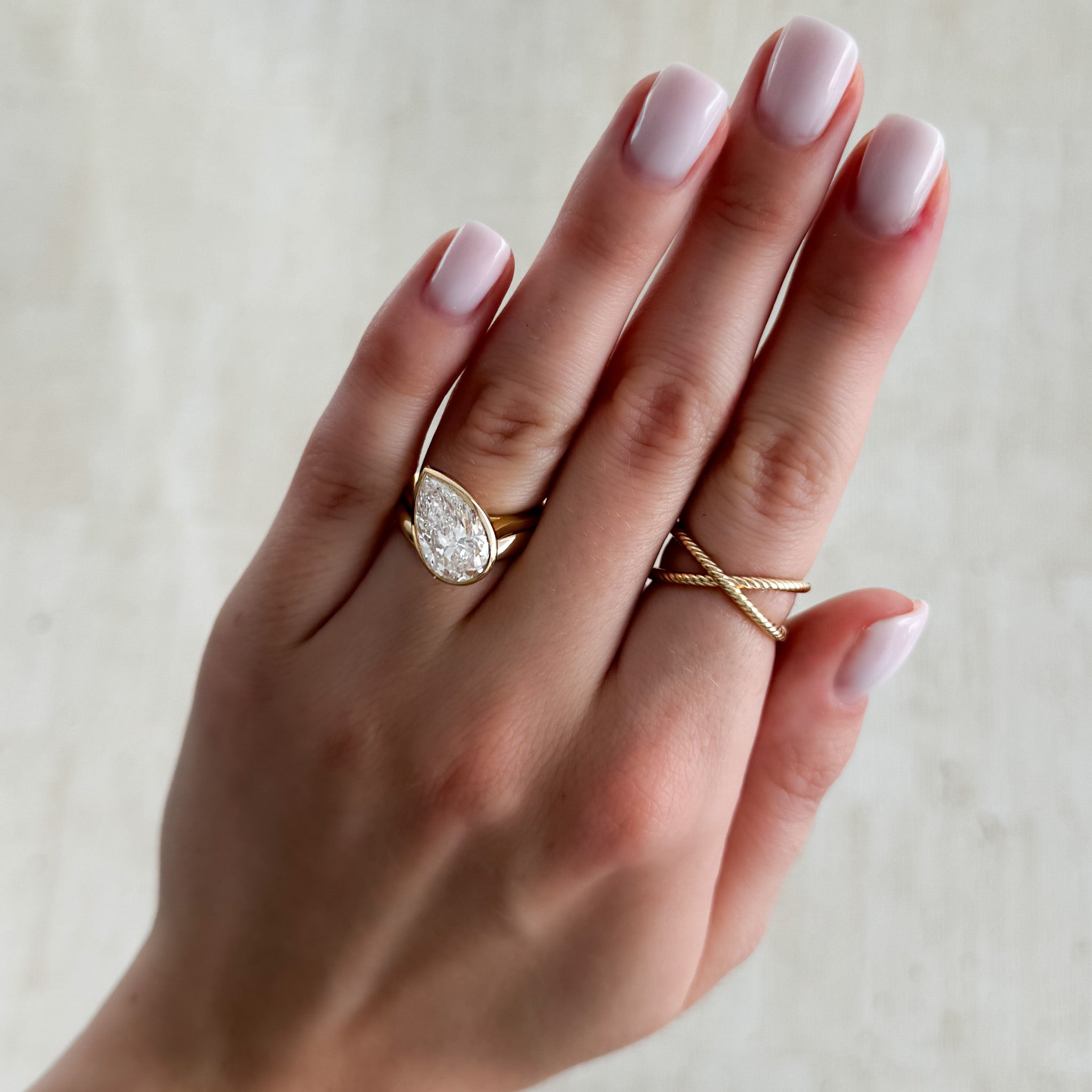 Penumbra Bezel Set Engagement Ring With Tilted Pear Cut