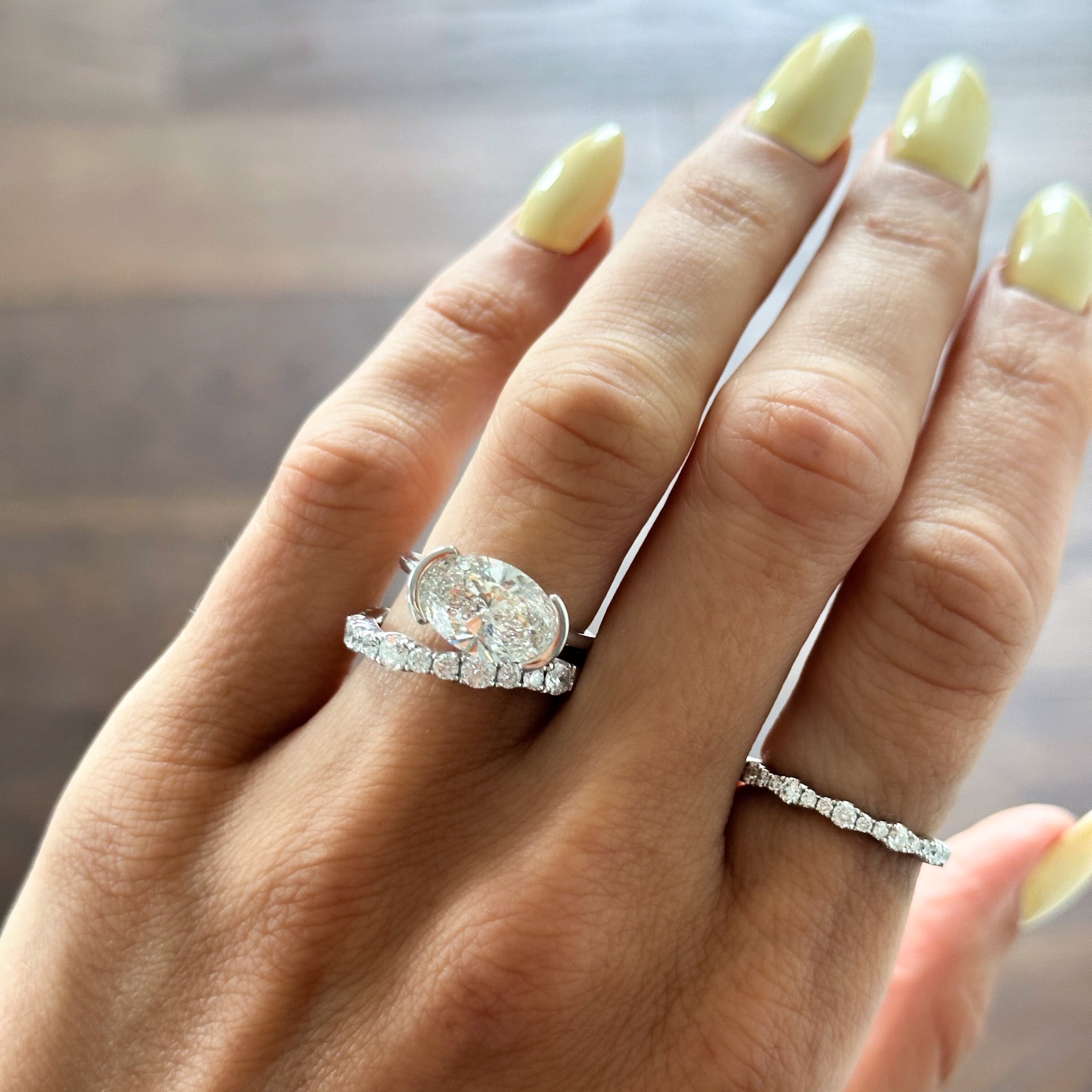 East West Half Bezel Solitaire Engagement Ring With Oval Cut Diamond