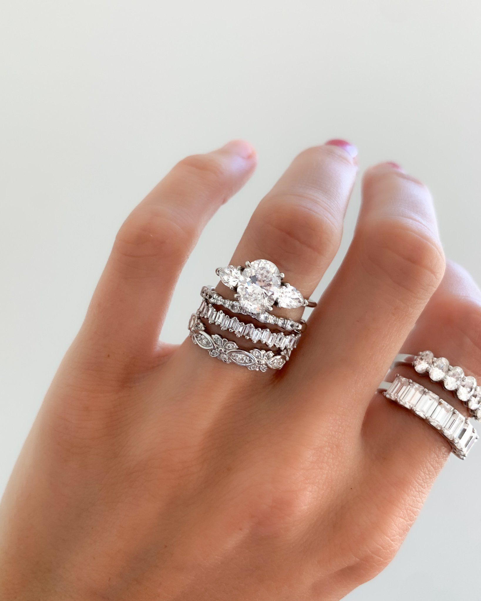 Three Stone Engagement Ring With Pear Side Stones and Oval Cut Diamond