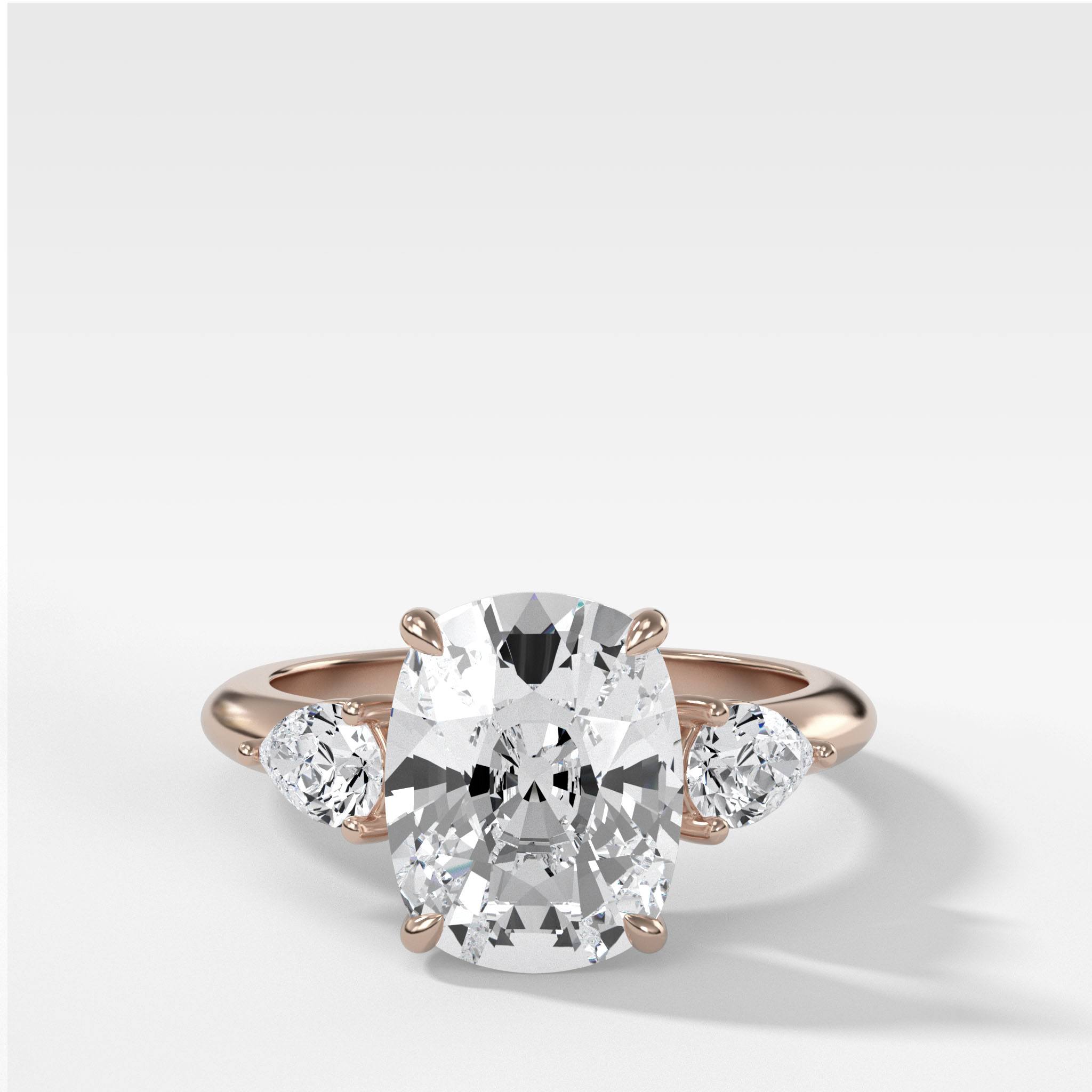 Three Stone Engagement Ring With Pear Side Stones and Elongated Cushion Cut Diamond