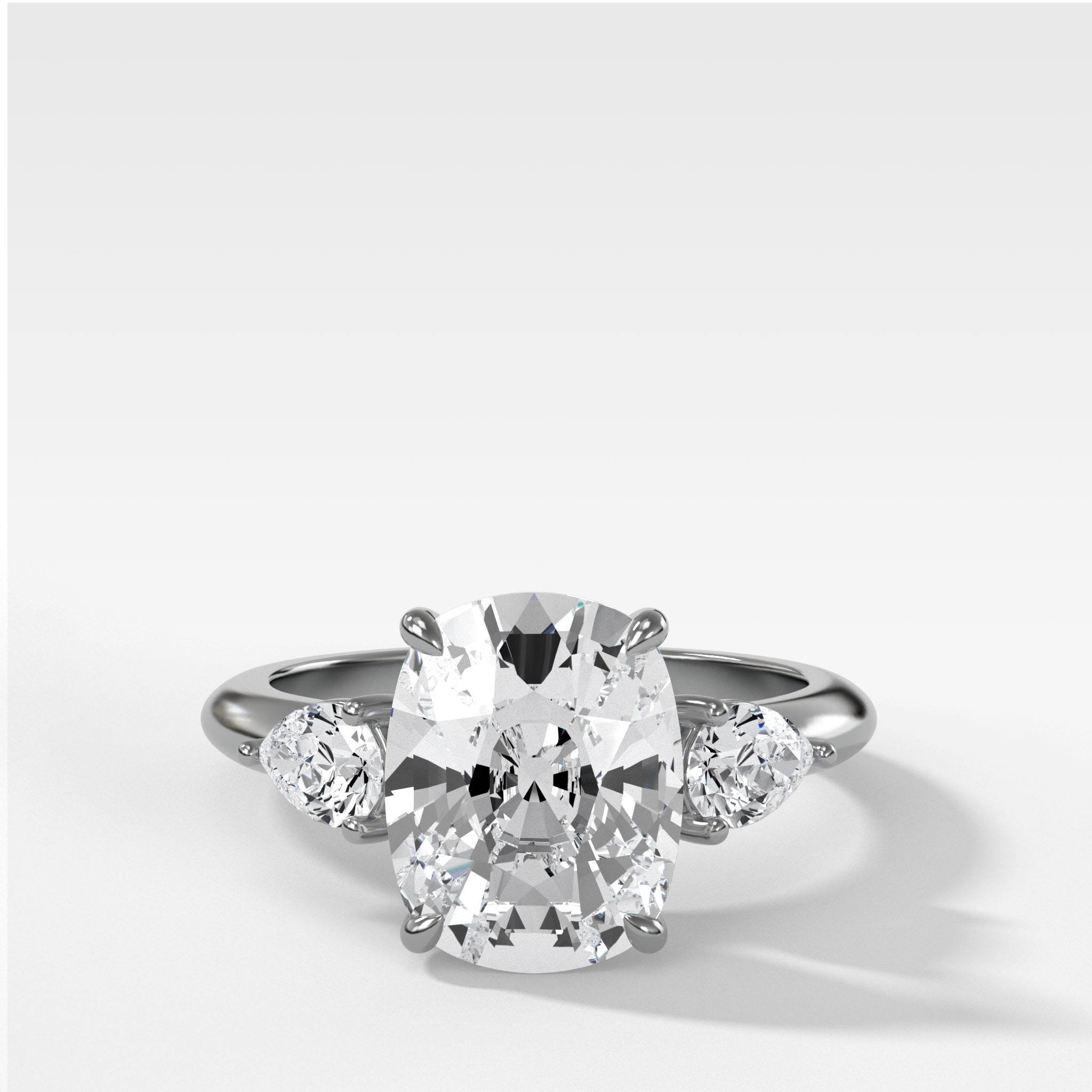 Three Stone Engagement Ring With Pear Side Stones and Elongated Cushion Cut Diamond