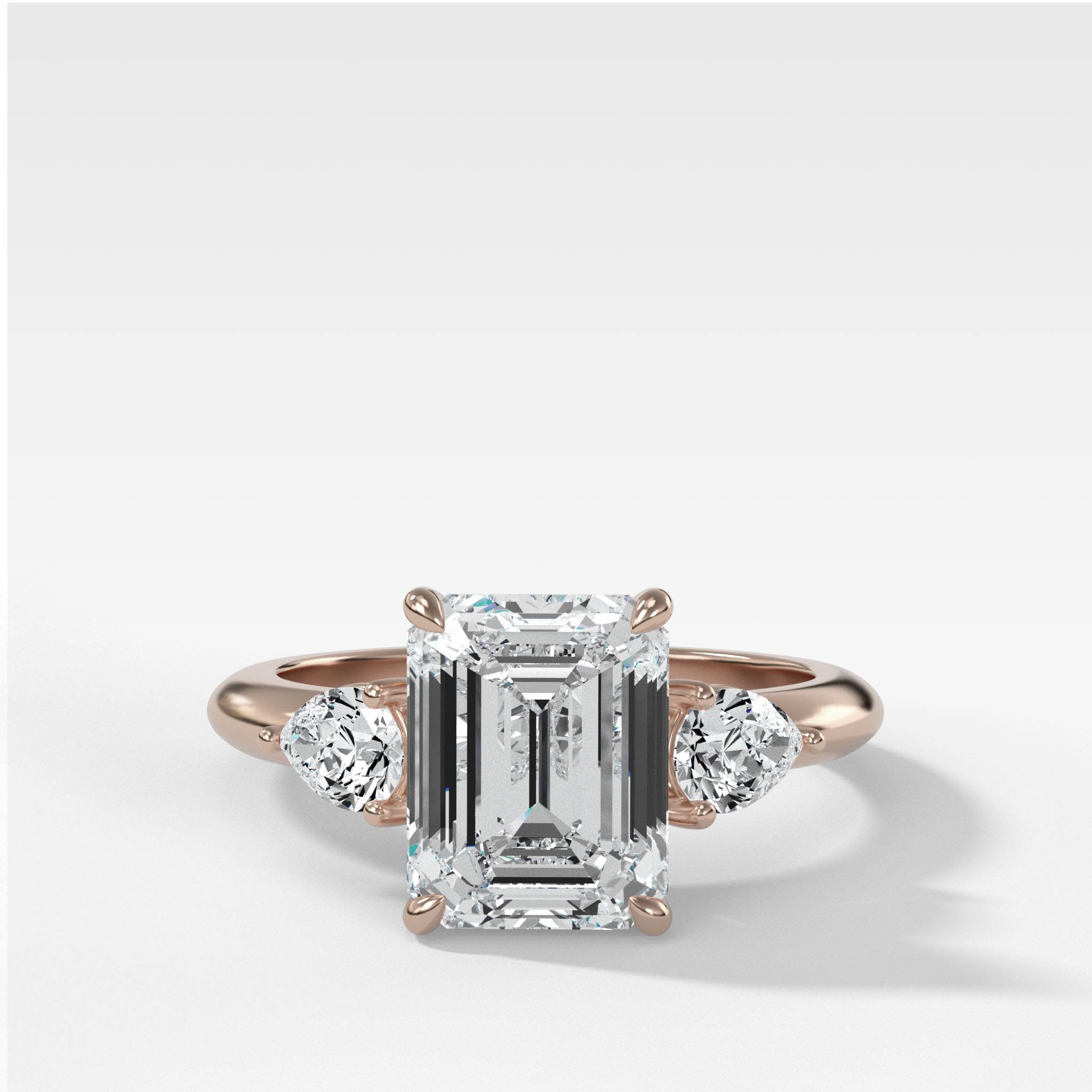 Three Stone Engagement Ring With Pear Side Stones and Emerald Cut Diamond