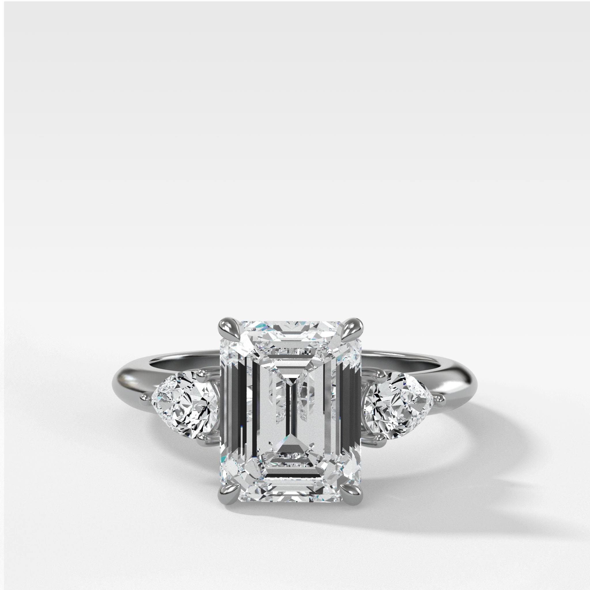 Three Stone Engagement Ring With Pear Side Stones and Emerald Cut Diamond