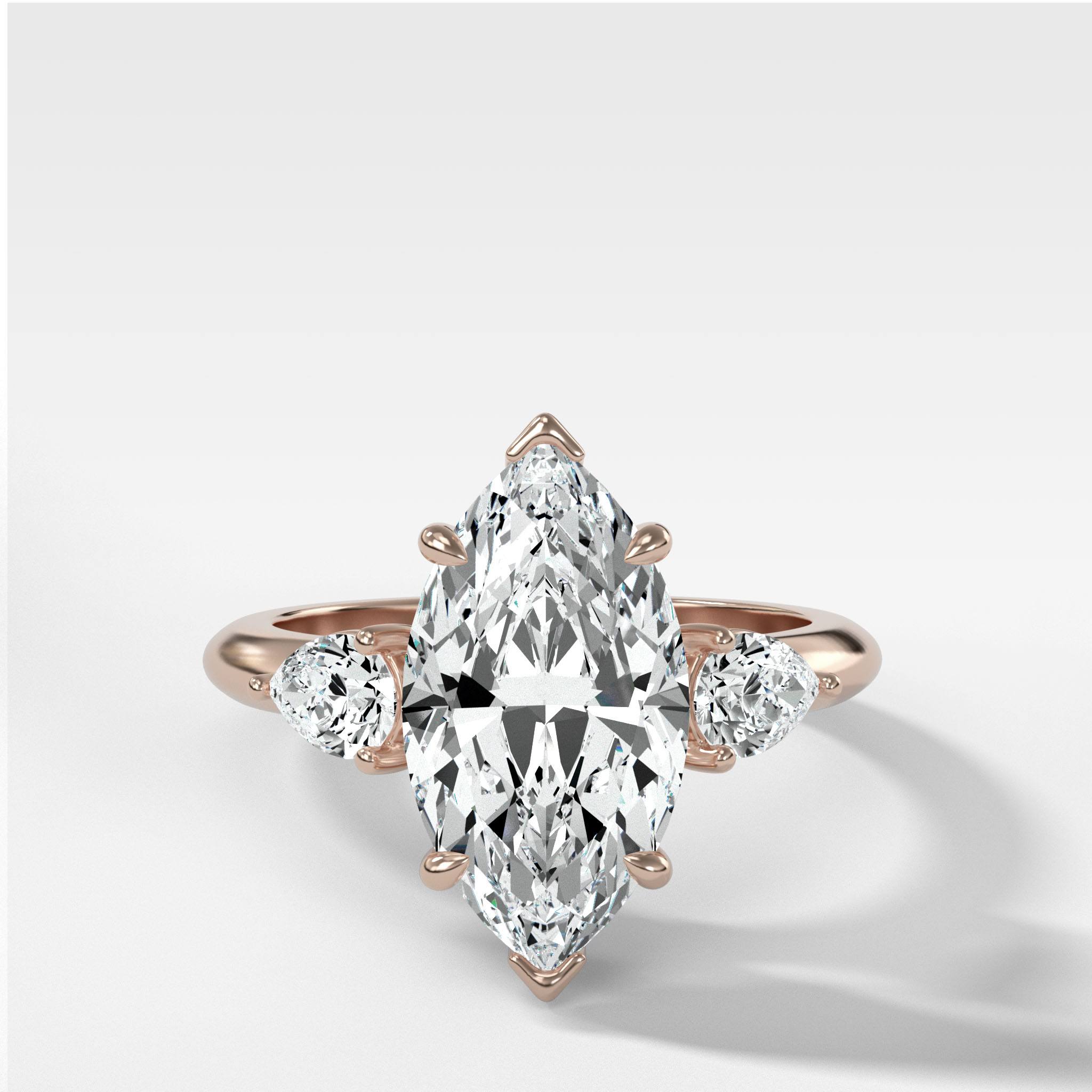 Three Stone Engagement Ring With Pear Side Stones and Marquise Cut Diamond