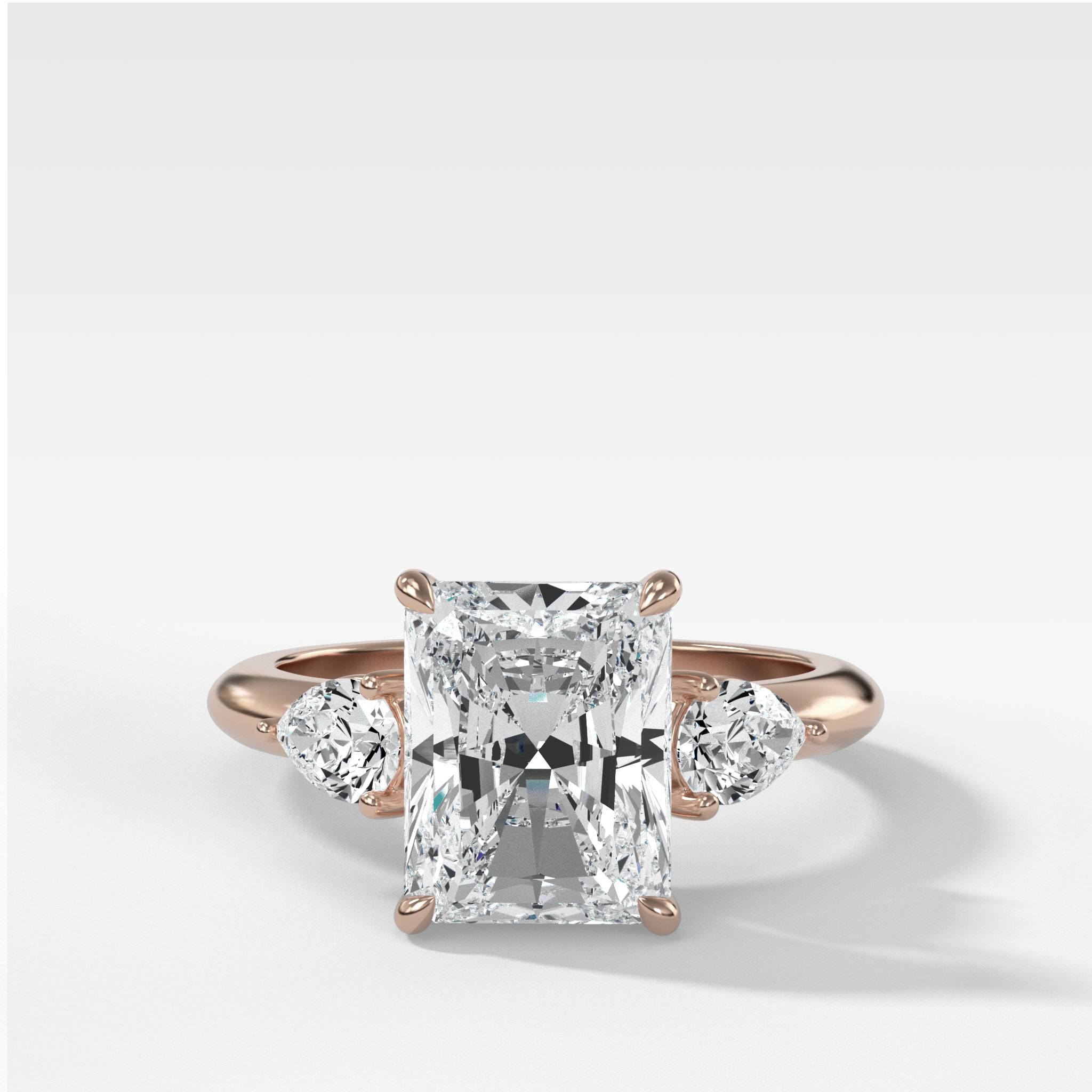 Three Stone Engagement Ring With Pear Side Stones and Elongated Radiant Cut Diamond