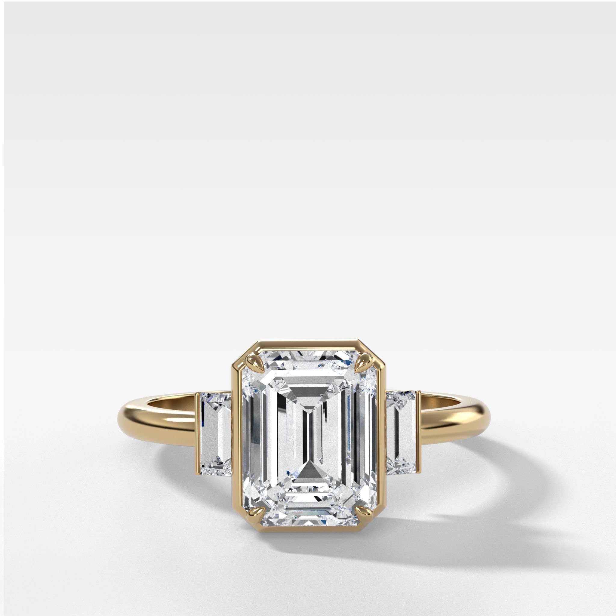 Three Stone Engagement Ring With Straight Baguette Side Stones and Emerald Cut Diamond