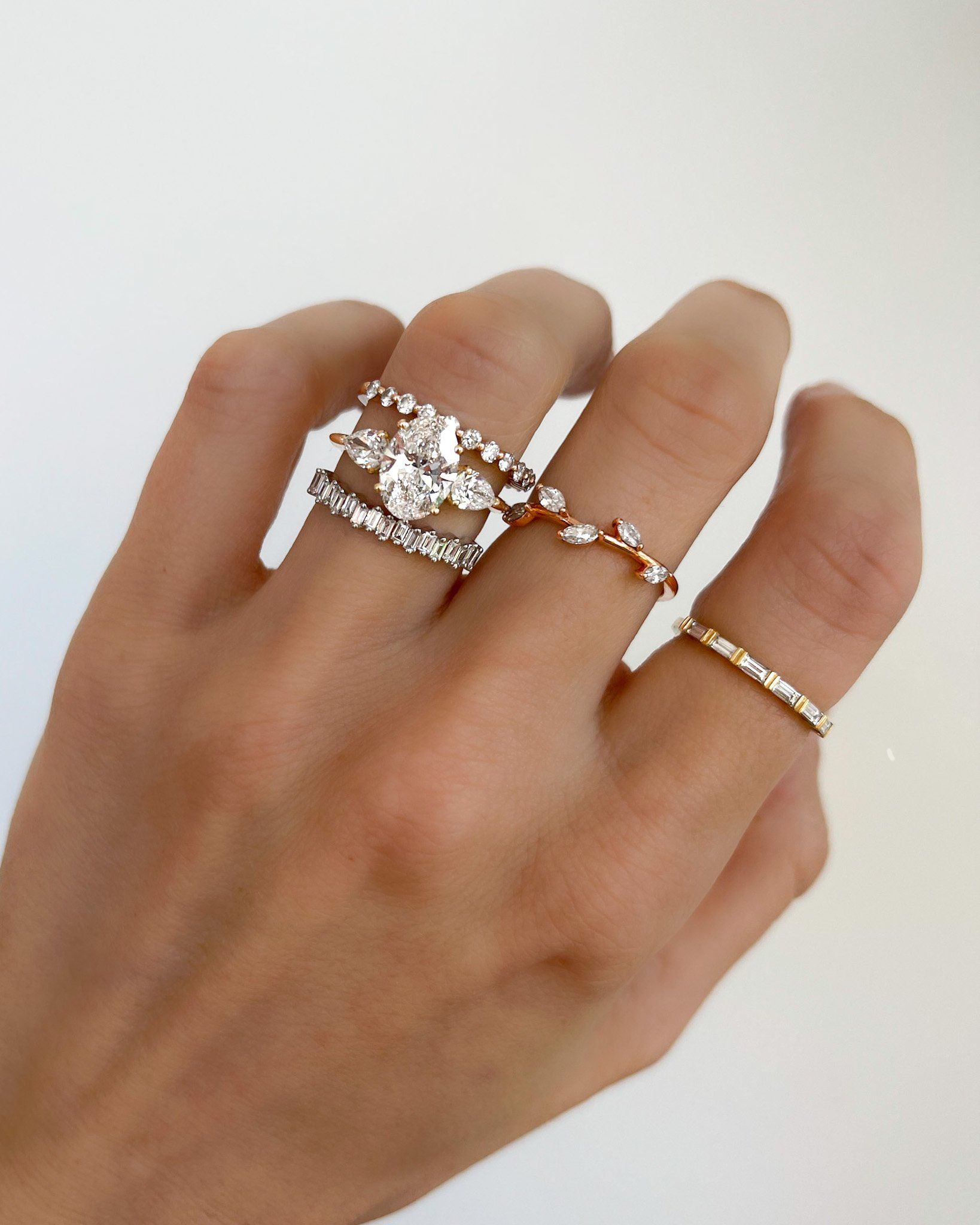 Three Stone Engagement Ring With Pear Side Stones and Oval Cut Diamond