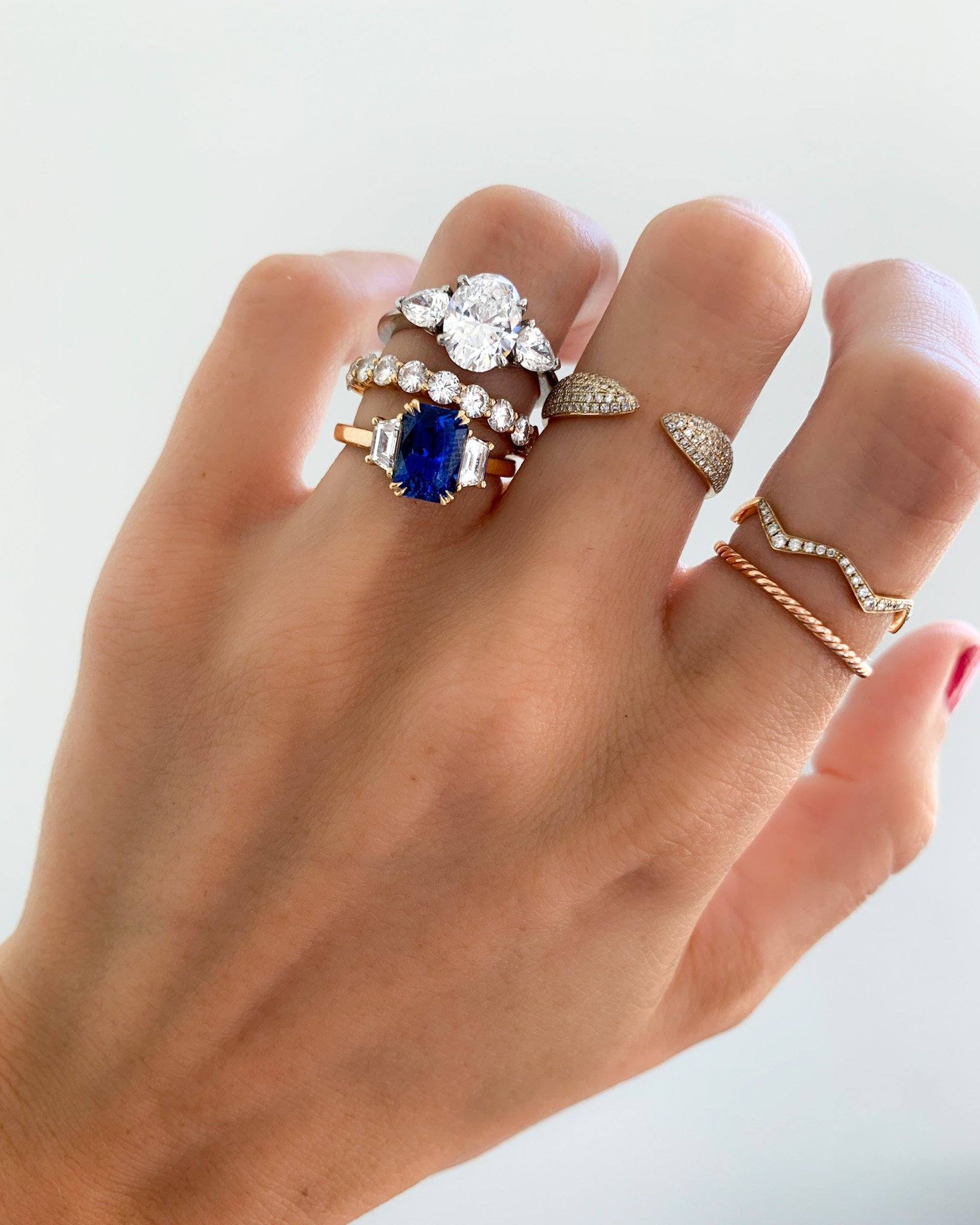 Three Stone Engagement Ring With Pear Side Stones and Oval Cut Diamond