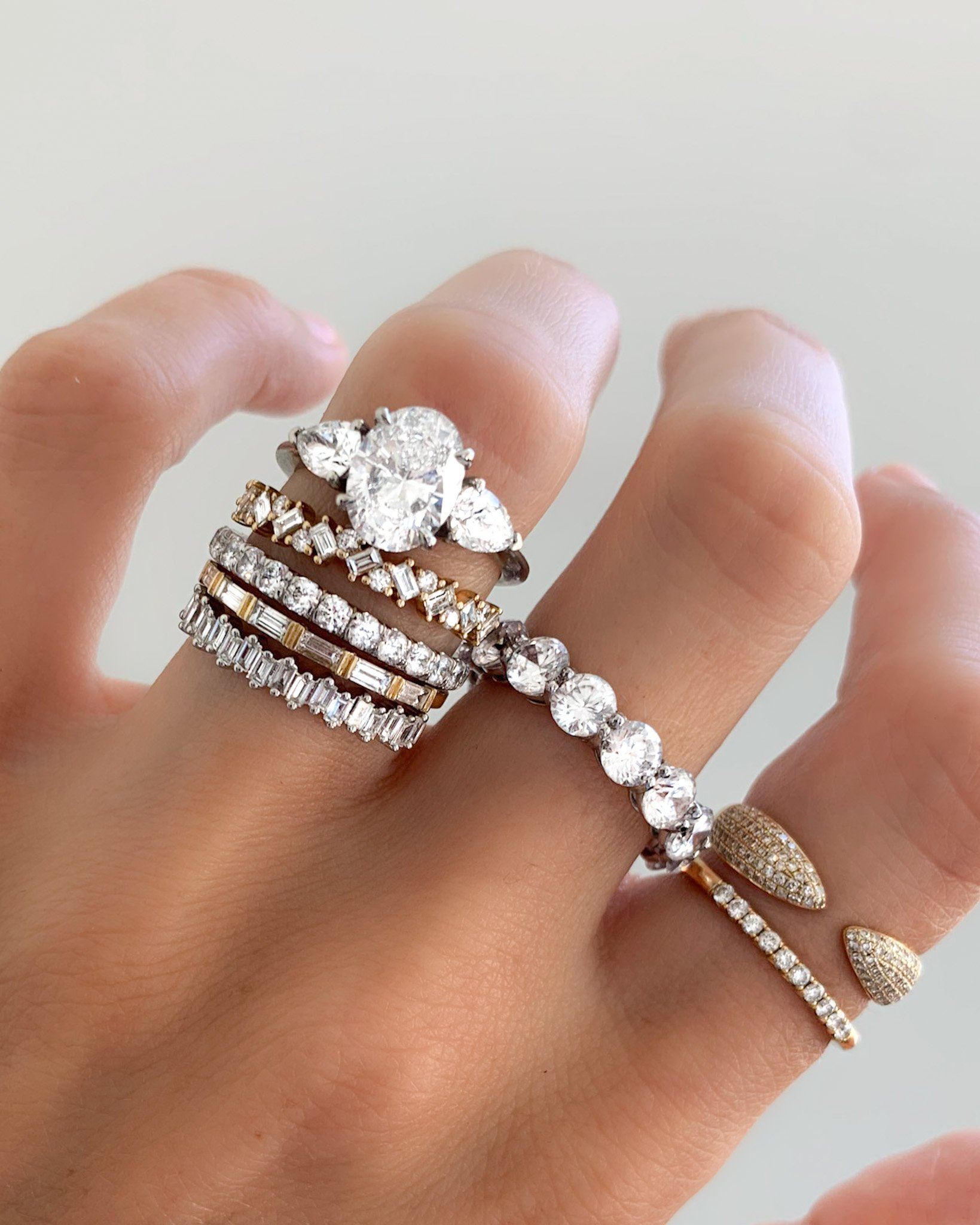 Three Stone Engagement Ring With Pear Side Stones and Oval Cut Diamond