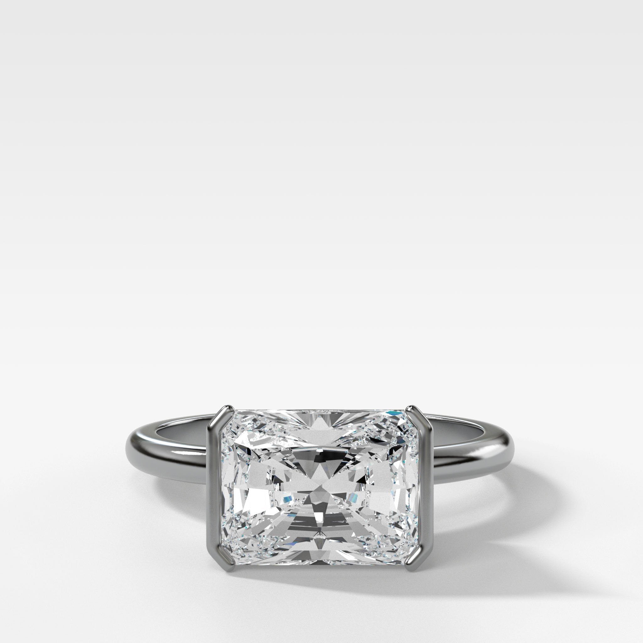 East West Half Bezel Solitaire Engagement Ring With Elongated Radiant Cut Diamond