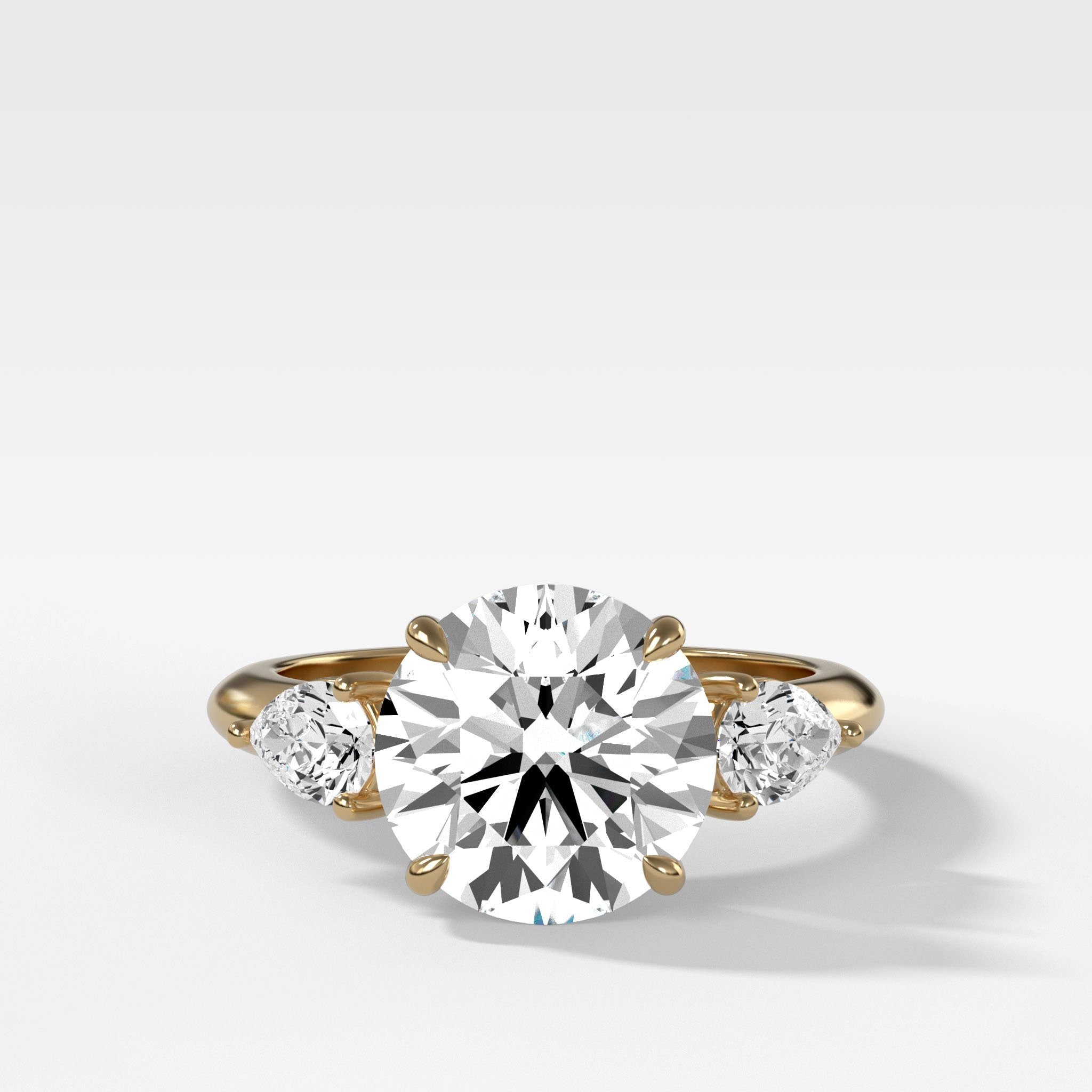 Three Stone Engagement Ring With Pear Side Stones With Round Cut Diamond