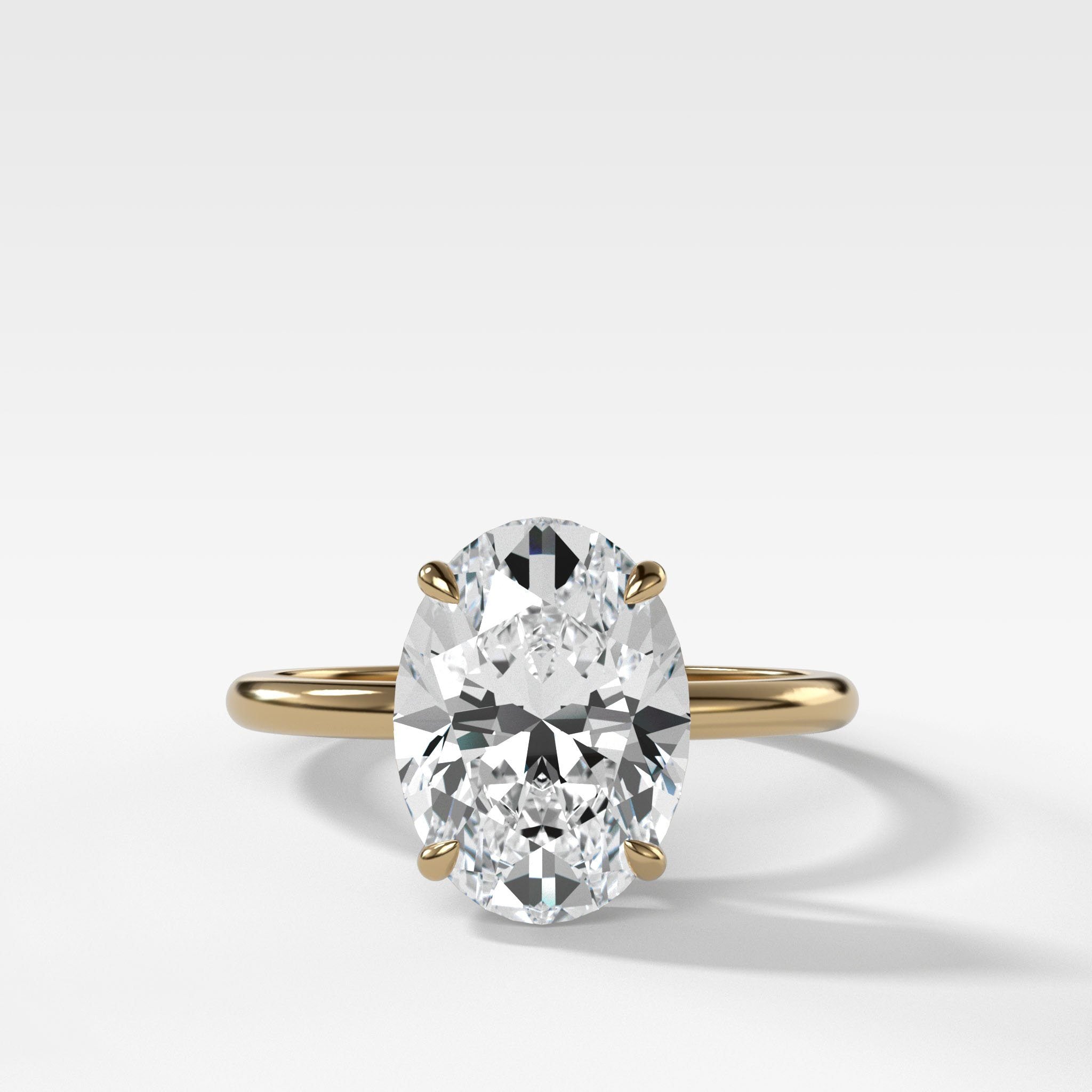 Thin + Simple Solitaire Engagement Ring With Oval Cut Diamond
