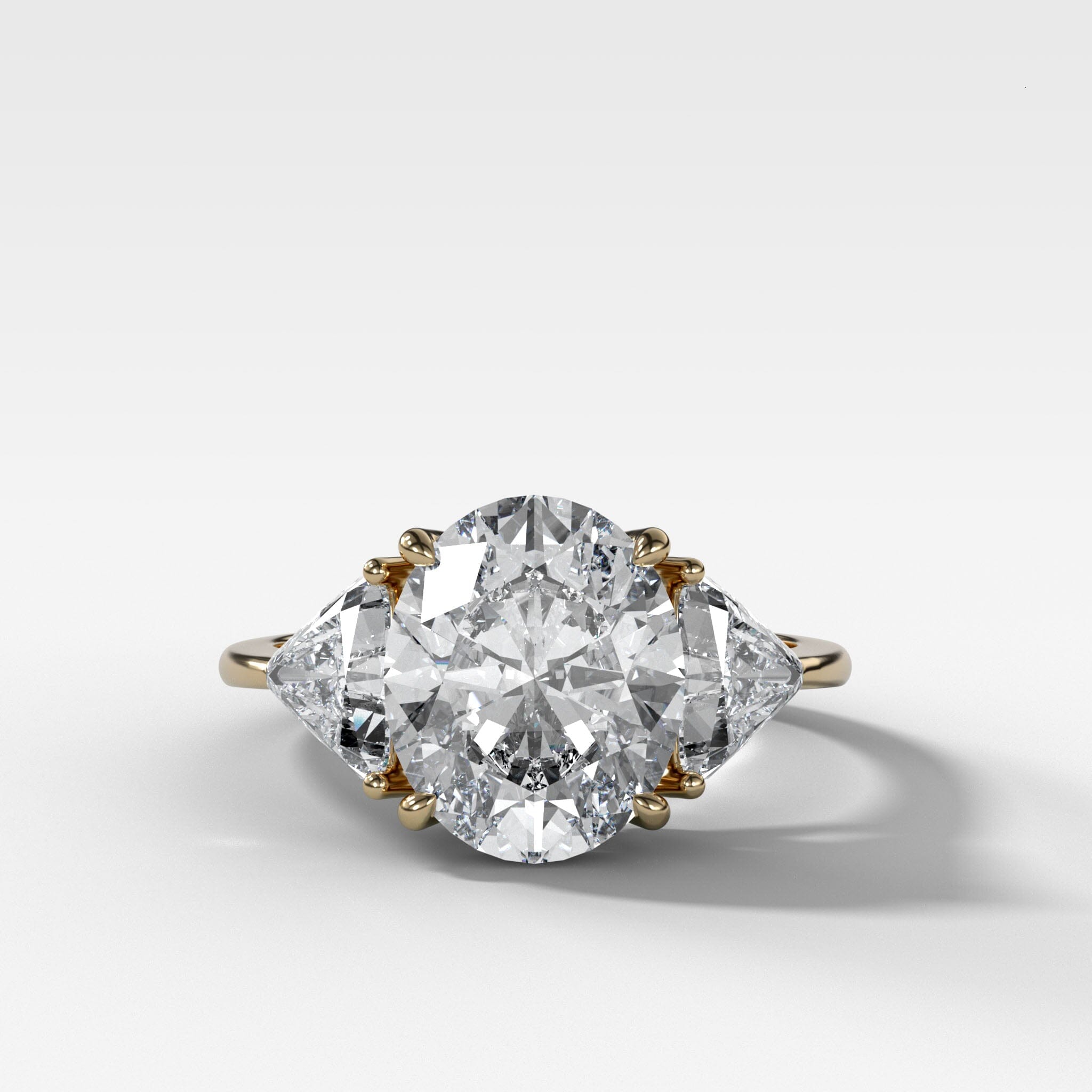 Three Stone Engagement Ring with Shield Side Stones and an Oval cut Diamond