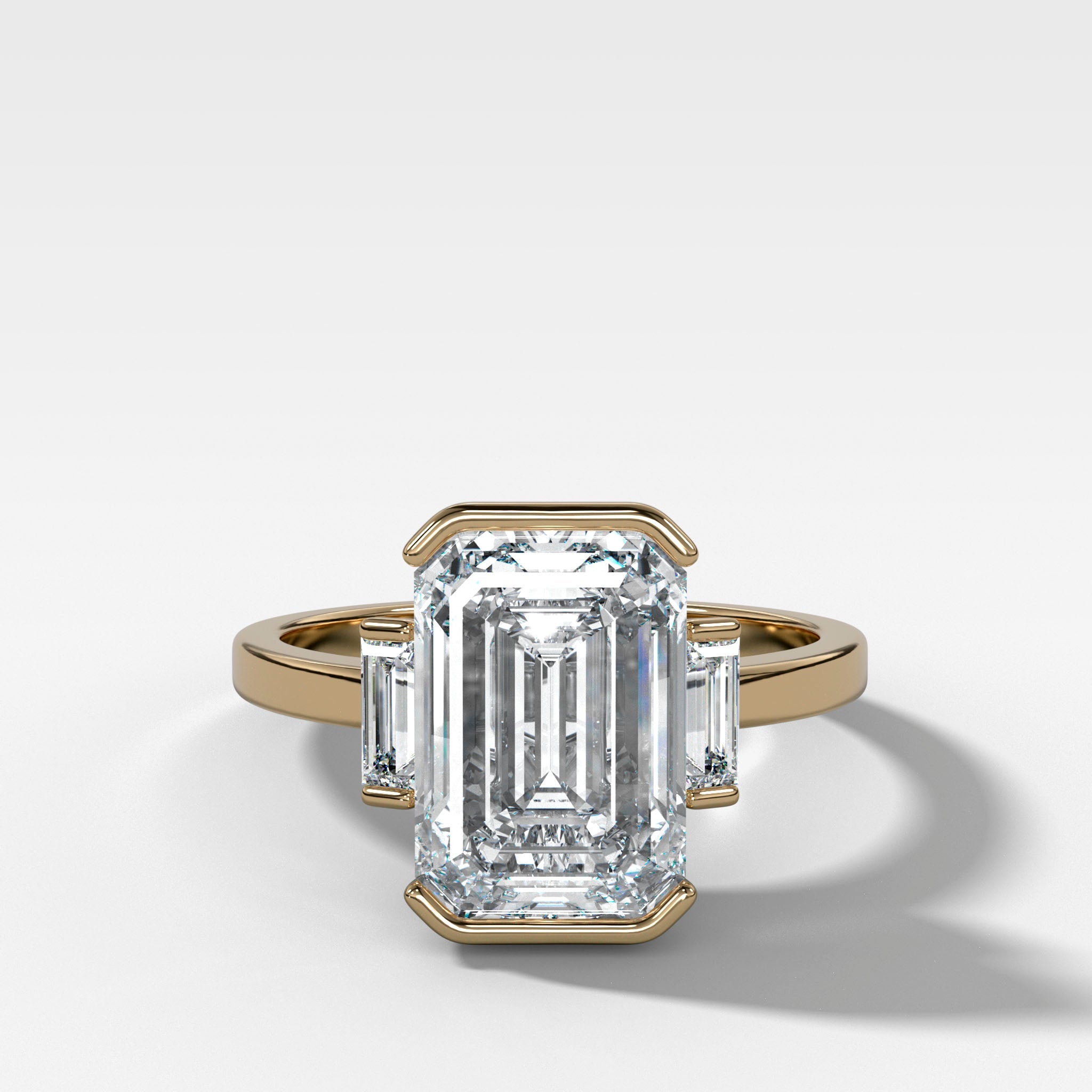 Three Stone Half Bezel Engagement Ring with Baguette Side Stones and Emerald Cut Diamond