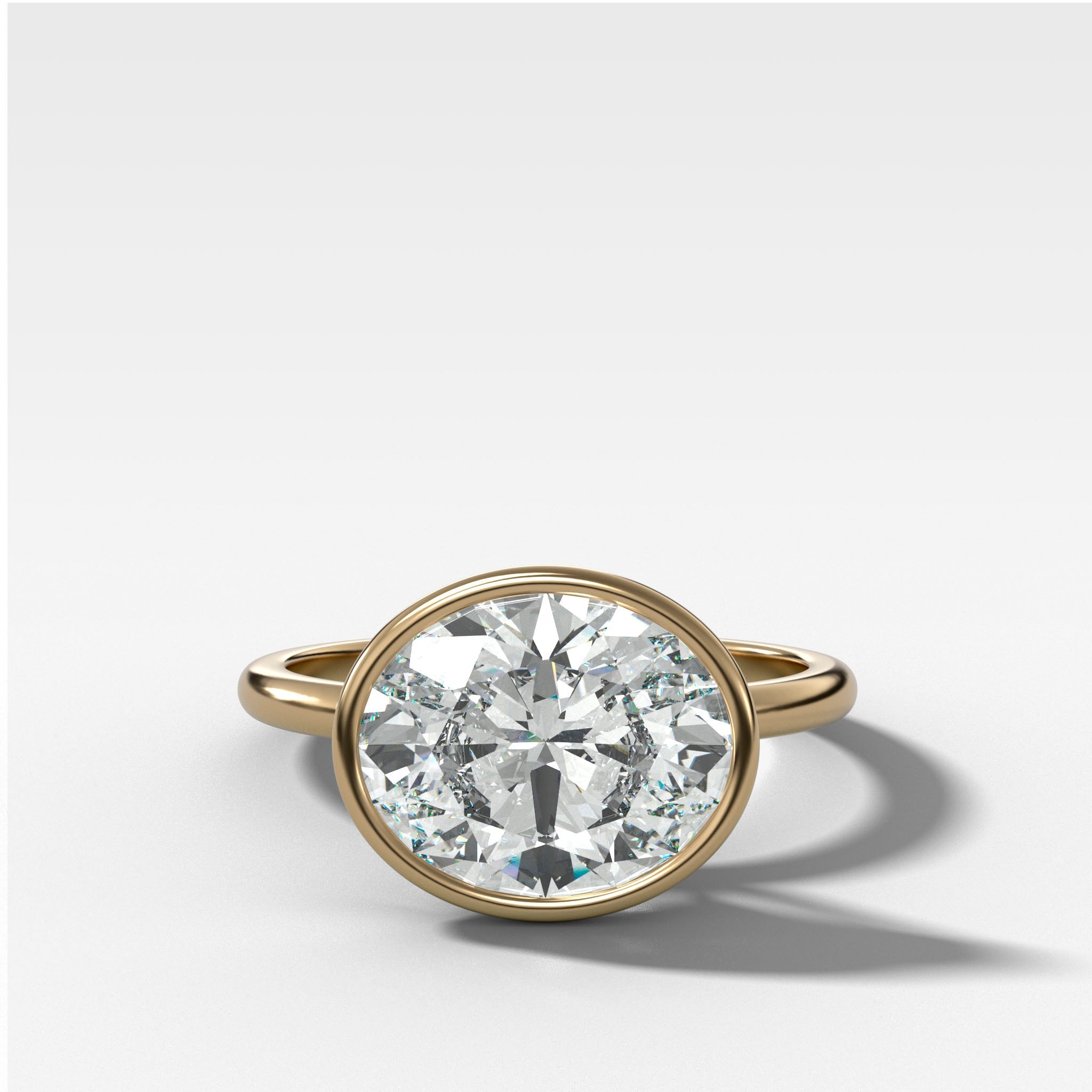 Penumbra Bezel Set Engagement Ring With East West Oval Cut