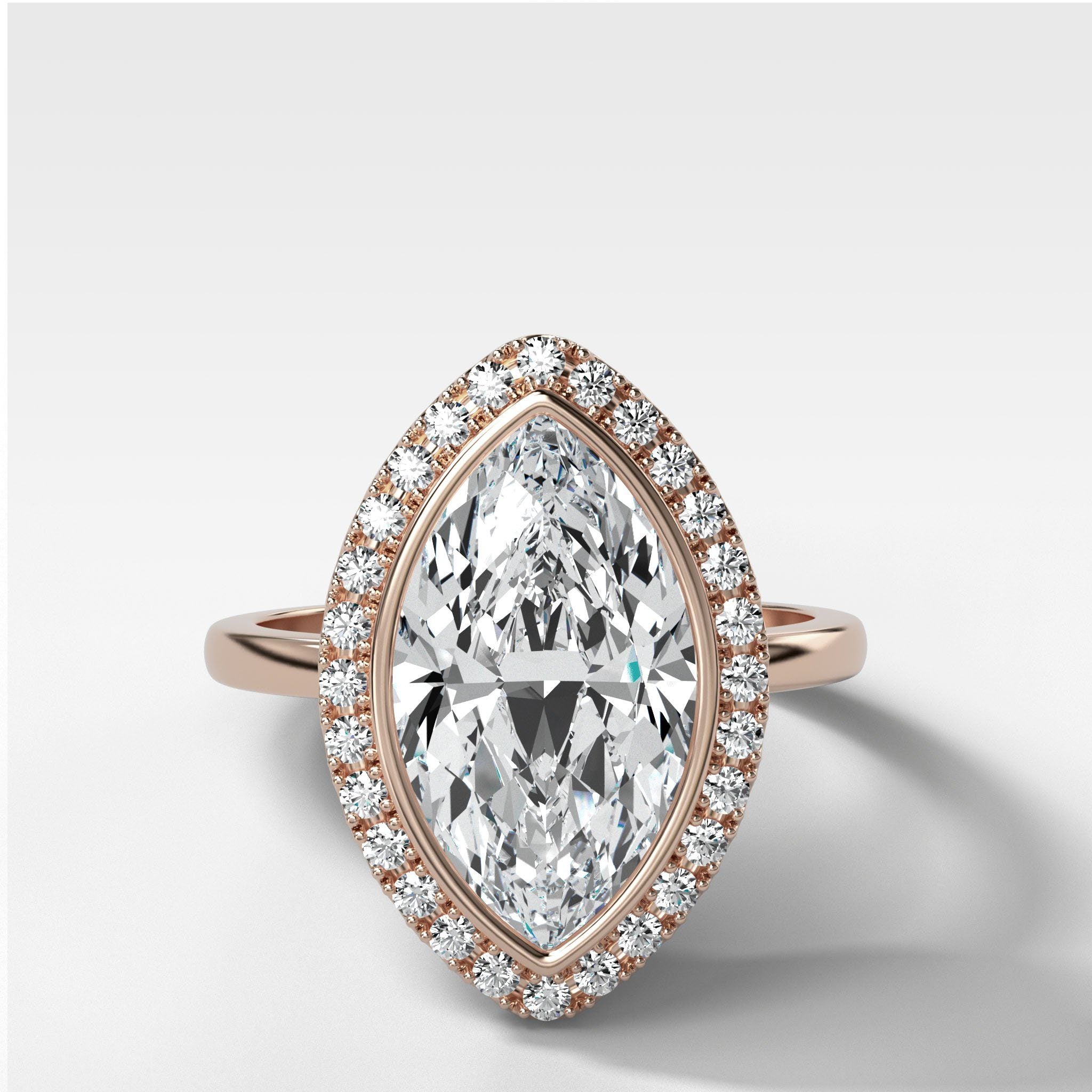 Bezel Set Halo Engagement Ring With Marquise Cut Diamond