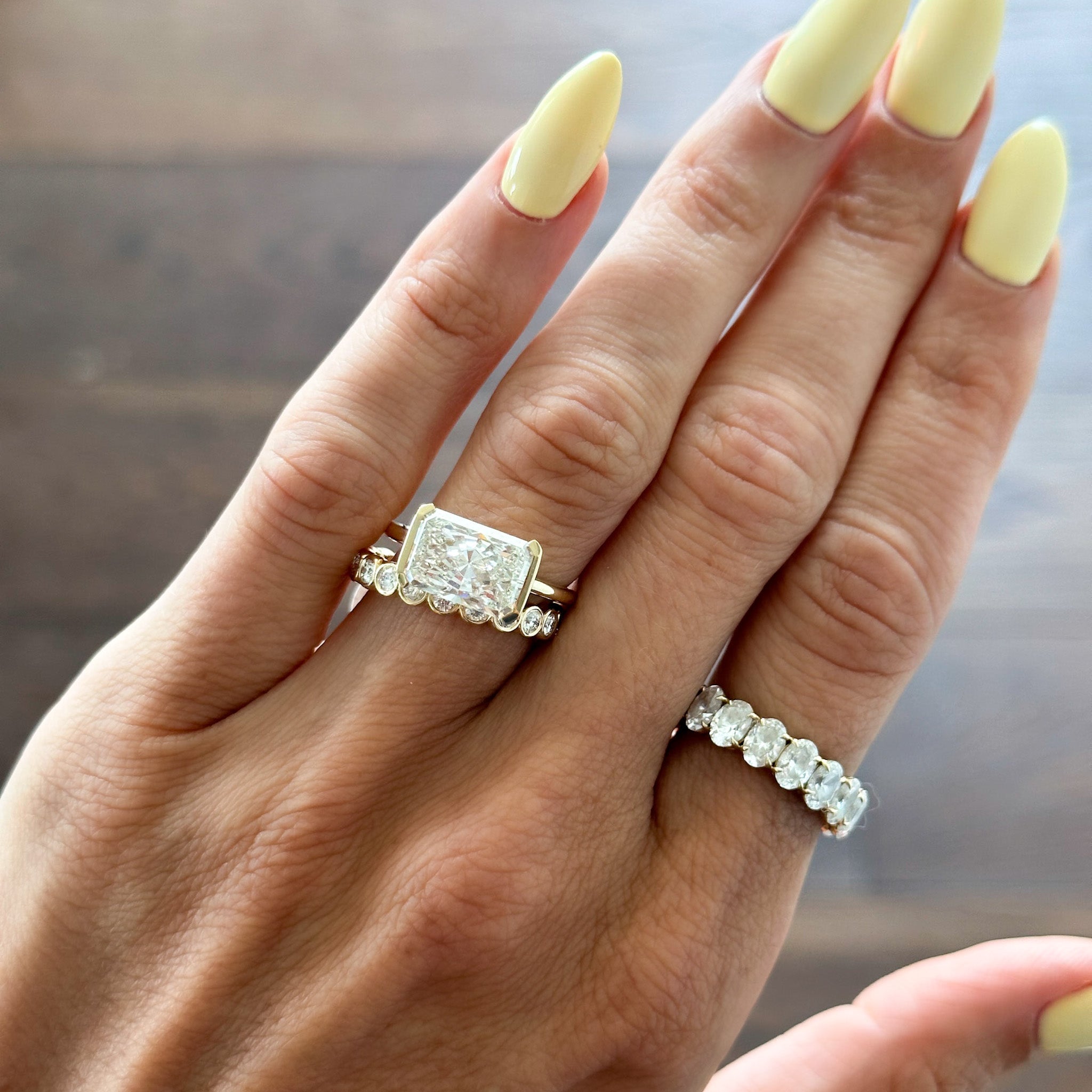 East West Half Bezel Solitaire Engagement Ring With Elongated Radiant Cut Diamond