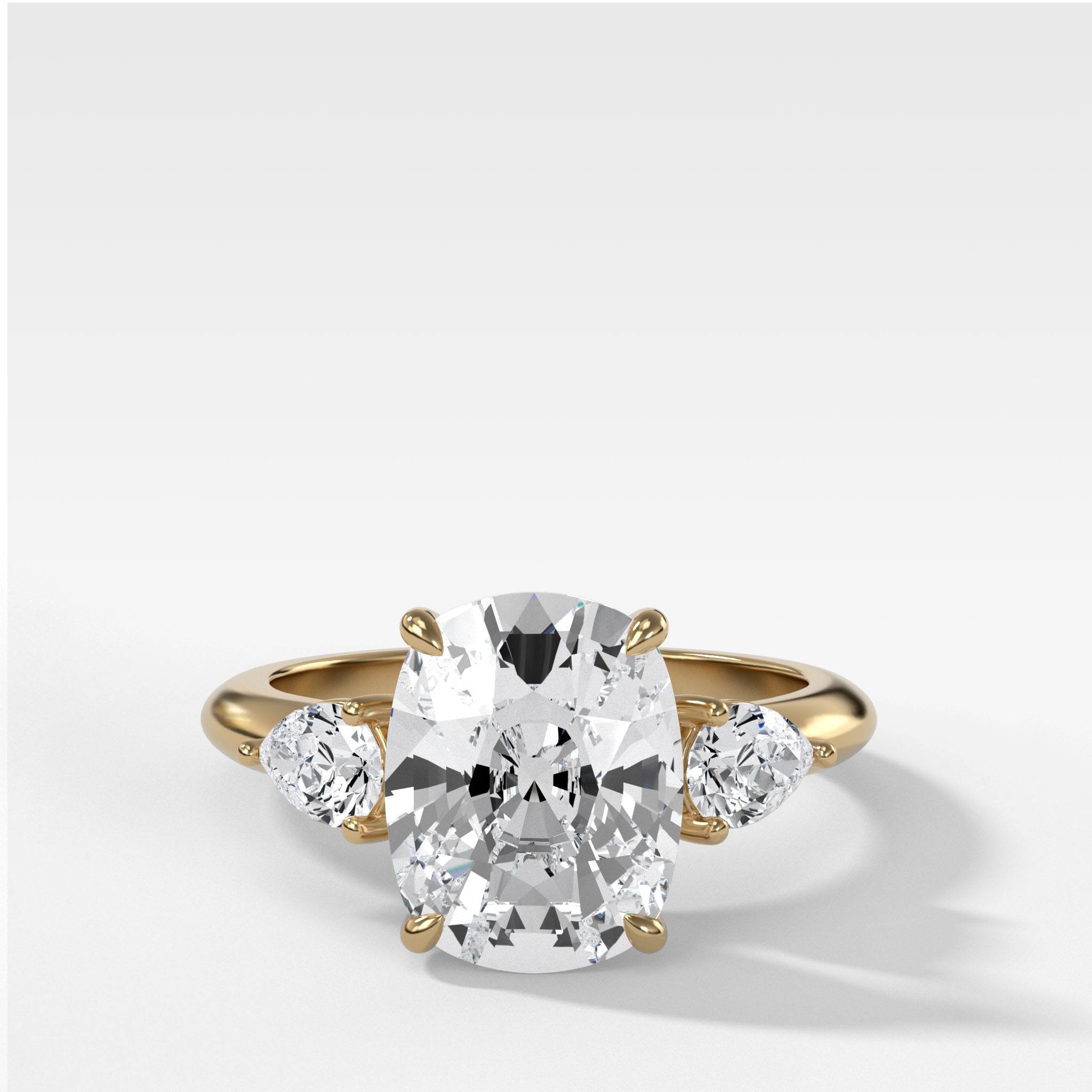 Three Stone Engagement Ring With Pear Side Stones and Elongated Cushion Cut Diamond