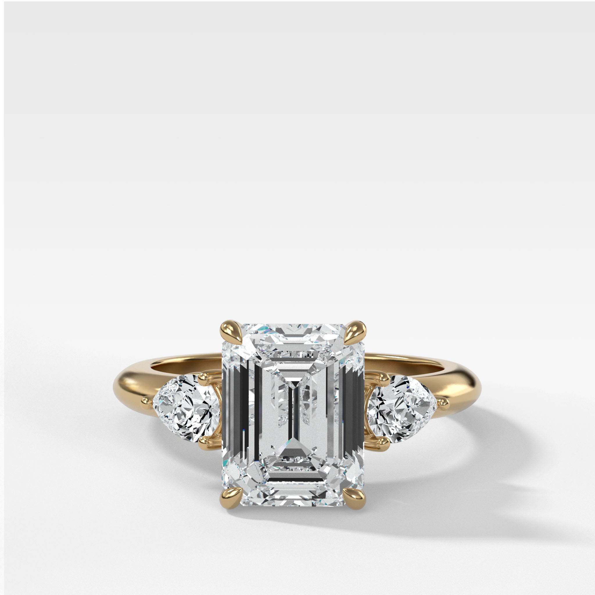 Three Stone Engagement Ring With Pear Side Stones and Emerald Cut Diamond