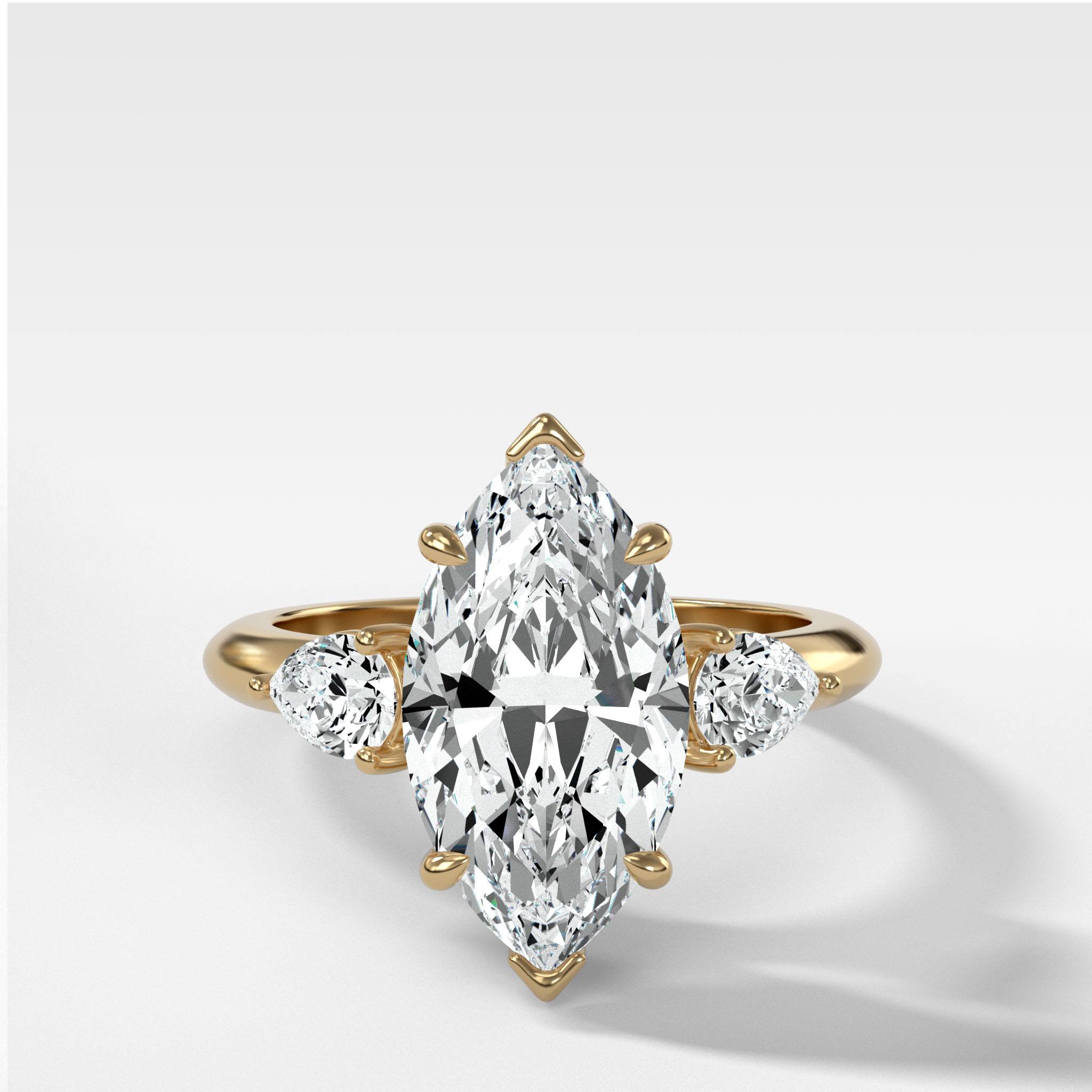 Three Stone Engagement Ring With Pear Side Stones and Marquise Cut Diamond
